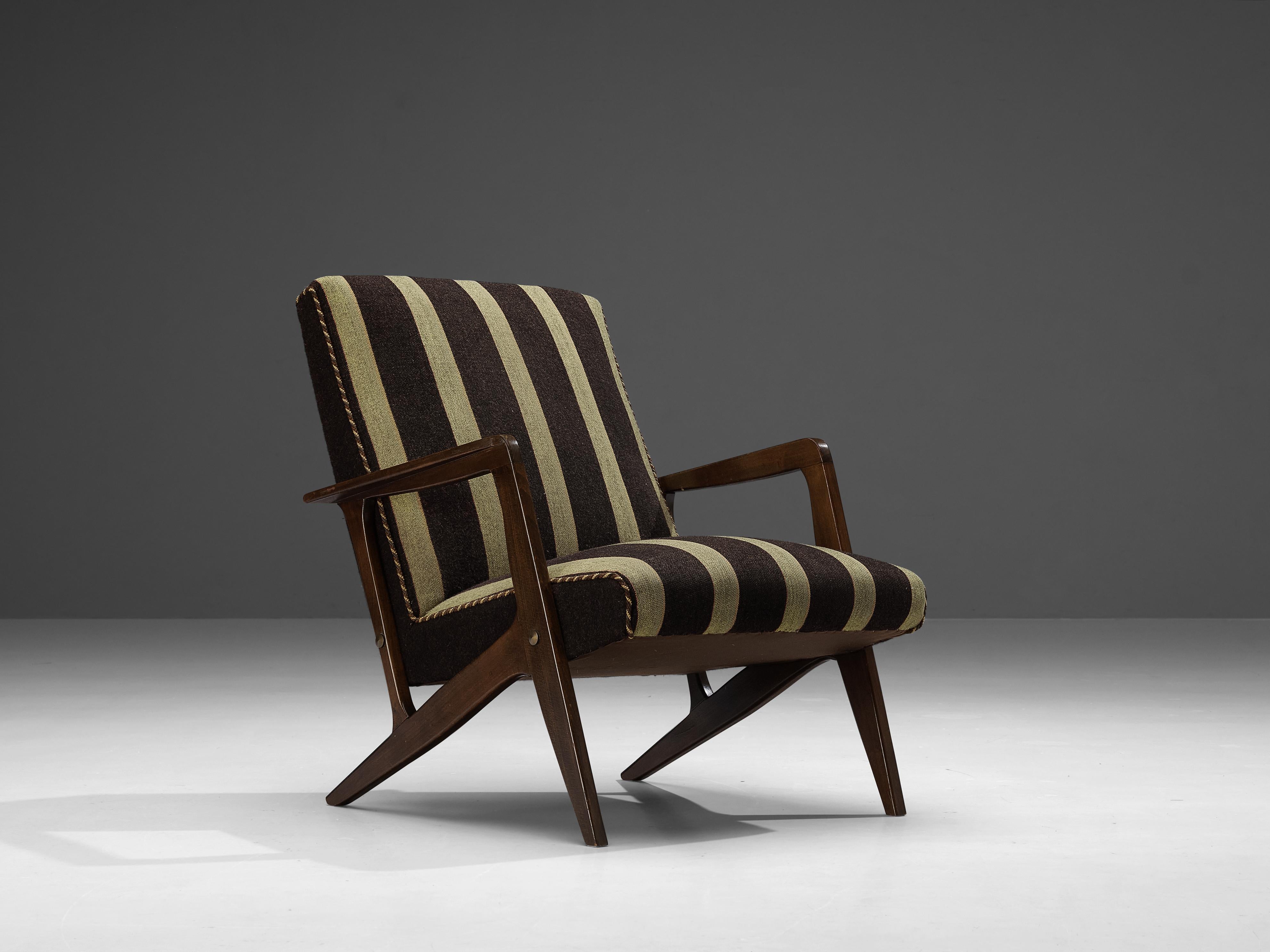 Lounge chair, fabric, stained beech, Denmark, 1950s

Danish lounge chair with elegant armrests in dark stained wood. The design of the frame and the tapered legs matches perfectly with the thick seat cushion and the backrest with tufted details. The