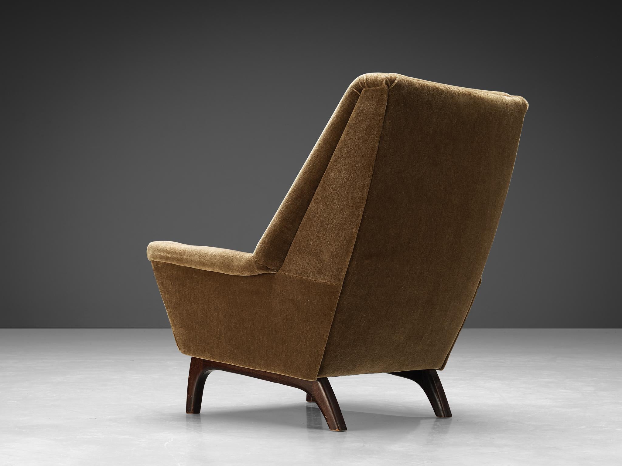 Lounge chair, dark stained teak, velvet fabric, Denmark, 1960s

This classic lounge chair of Danish origin features modest and subtle lines and shapes that emphasize the clear construction of the design. A nice detail is how the back elegantly runs
