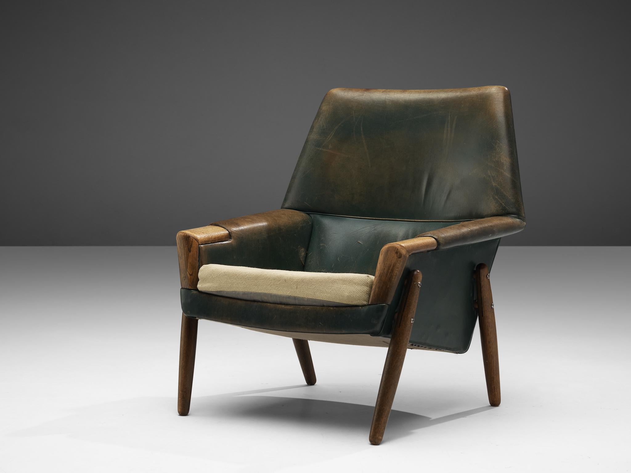 Lounge chair, leather, oak, Denmark, 1960s

Stunning Danish lounge chair with admirable patina. This Danish chair features quintessential design aesthetics. It shows very elegant shapes and real nice details, like the almost perfect shaped