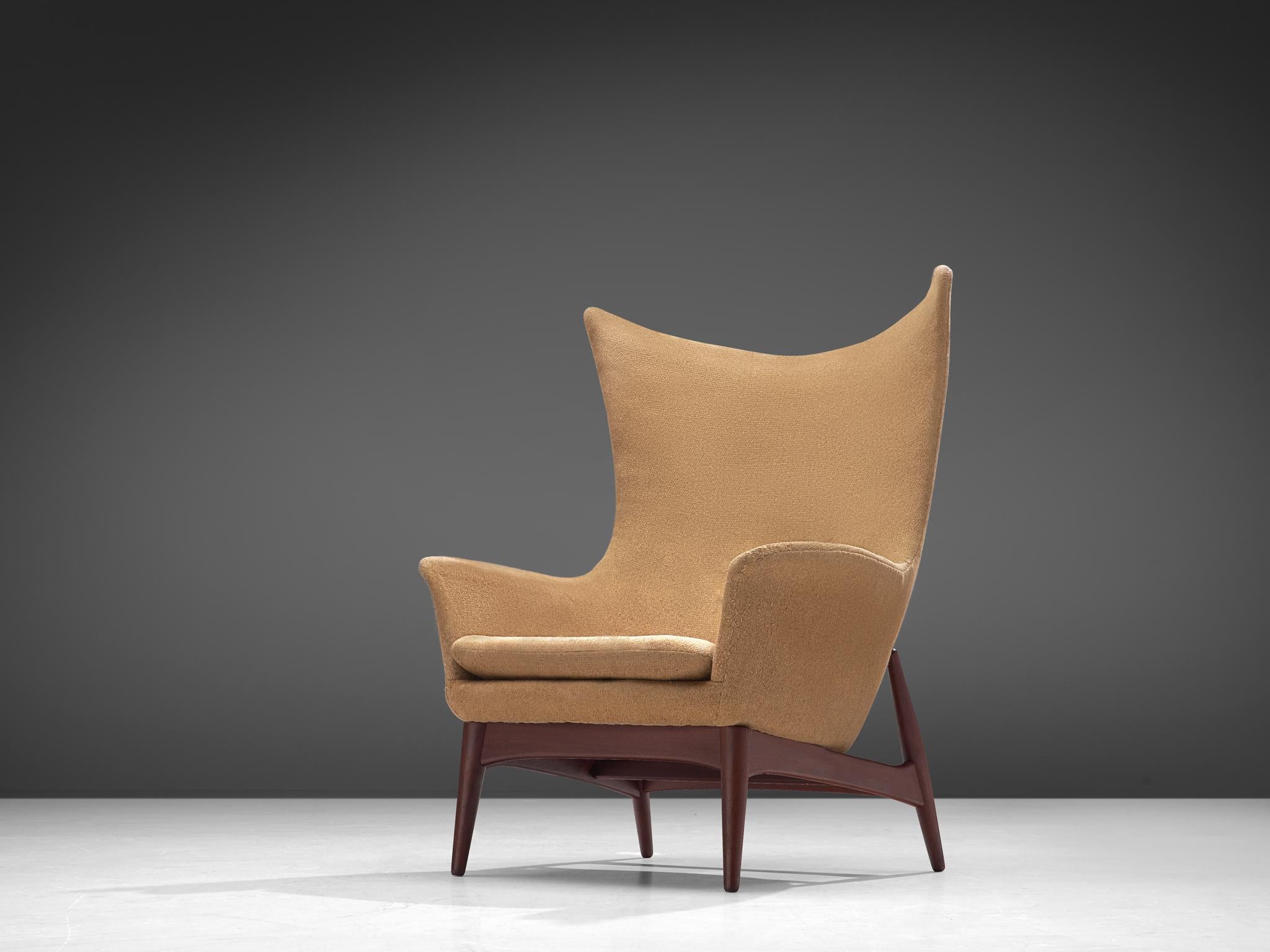 Lounge chair, fabric, teak, Denmark, 1960s

Sculptural egg-shaped lounge chair made in Denmark in the 1960s. This wingback chair is a wonderful example of Scandinavian design, featuring a high, shell inspired backrest that embraces the seater. The