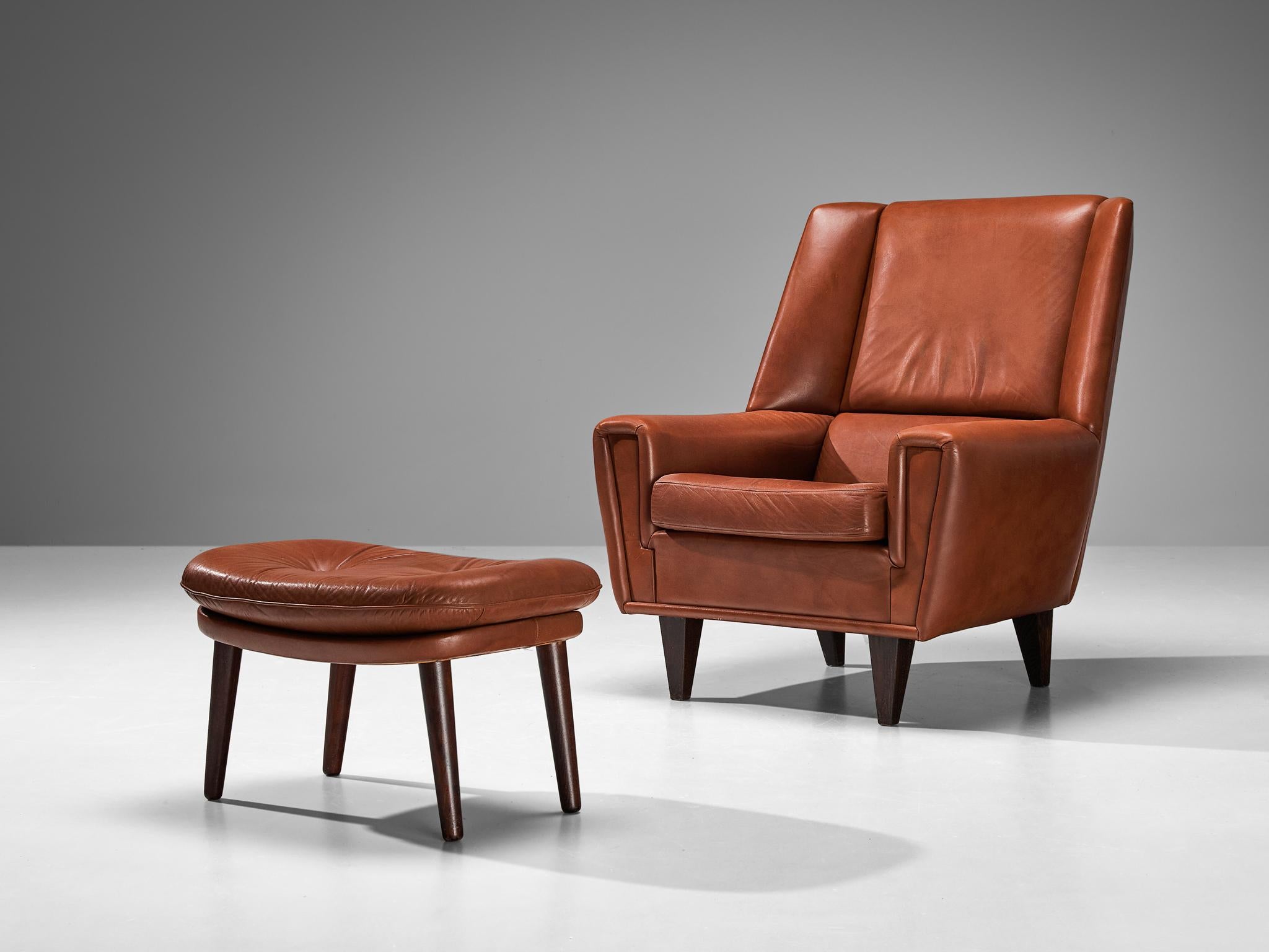 Danish cabinetmaker, lounge chair with ottoman, in brown leather and oak, Denmark, circa 1960.

This chair with ottoman is made to reach an ultimate level of comfort as can clearly be recognized in the design. This Danish chair features