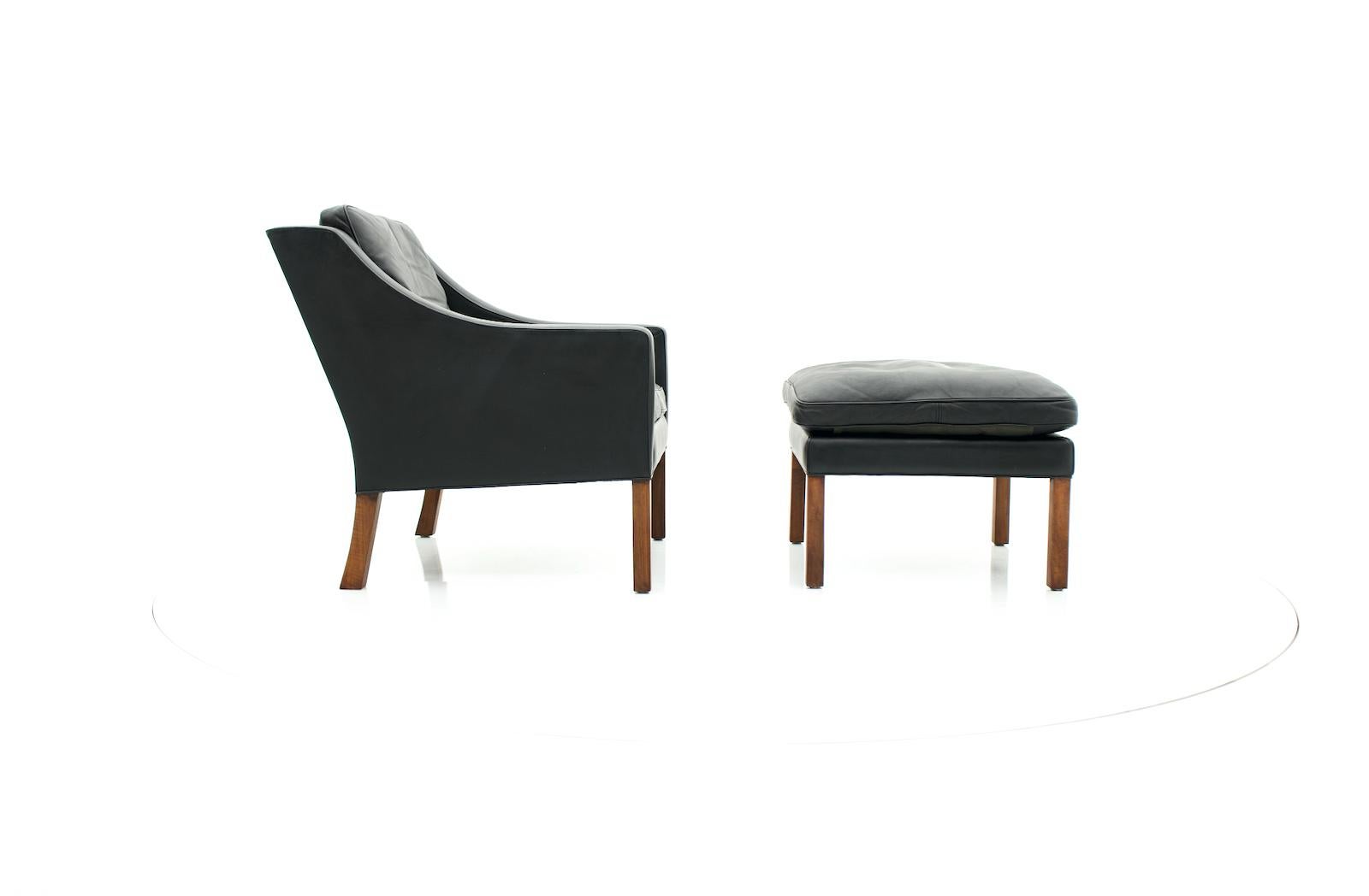 Mid-20th Century Danish Vintage Lounge Chair with Stool in Black Leather 1960s For Sale