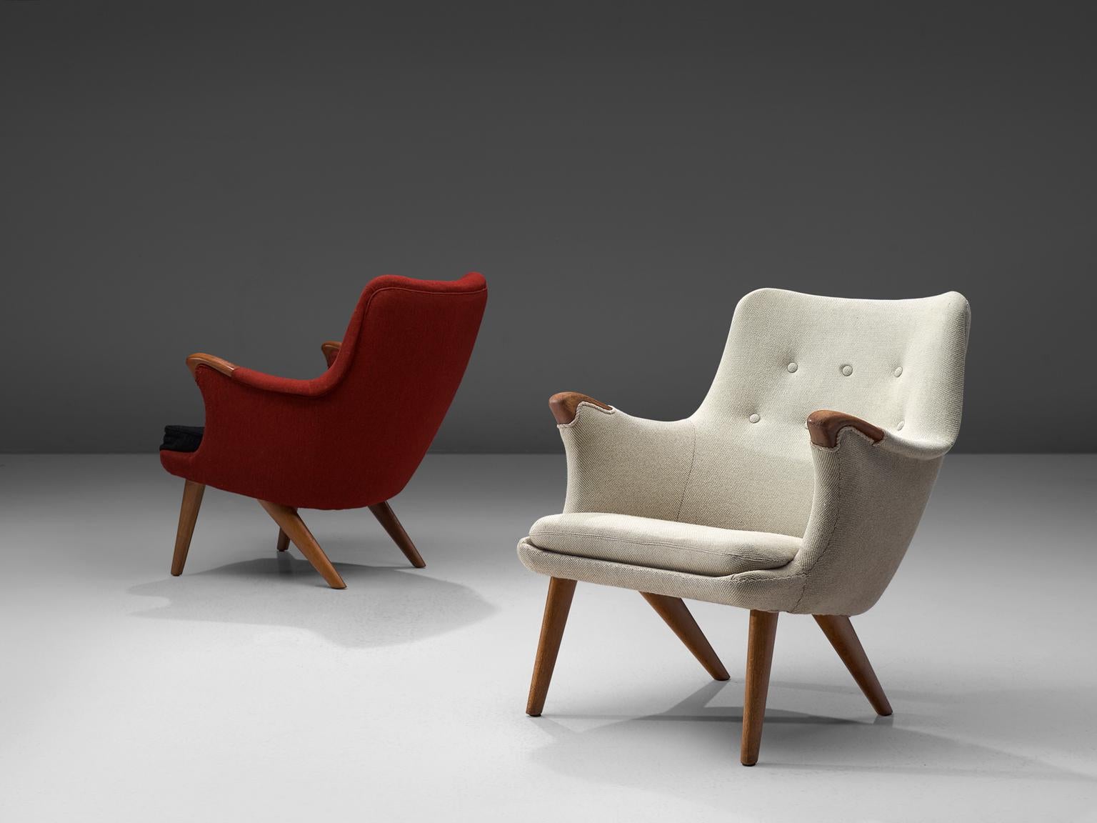 Set of 2 Danish armchairs, oak and red fabric, Denmark, 1960s.

These lounge chairs have an open expression and an elegant shape due to its round shapes. The armrests have flow loosely in the seat, giving the idea of someone spreading its arms