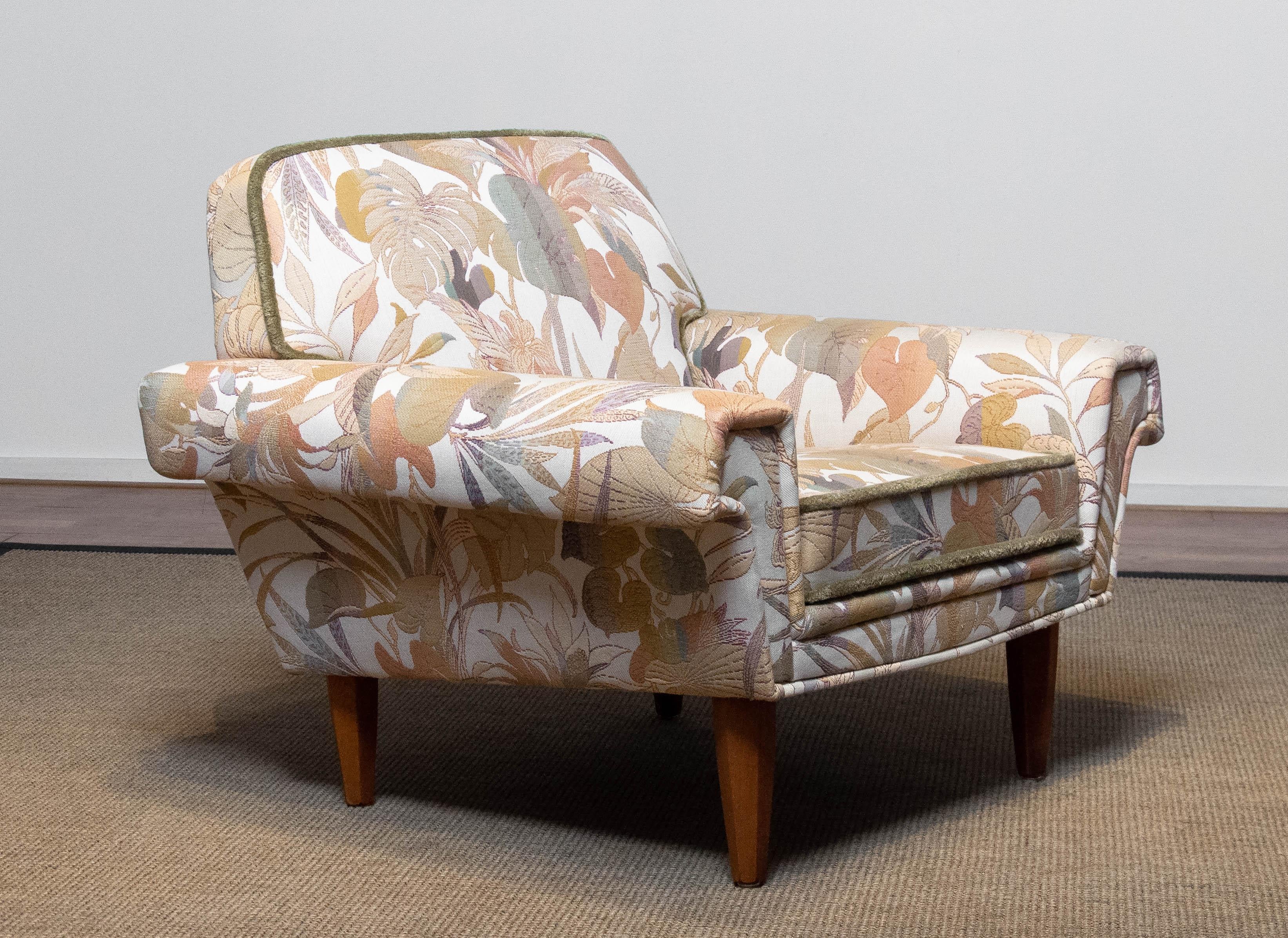 Excellent restored ( in the 1970's ) low back lounge / club chair from Denmark from the 1950's upholstered with beautiful multi colored Jacquard fabric. The chair is in absolutely great and clean condition. Sits and supports very good.
The legs are