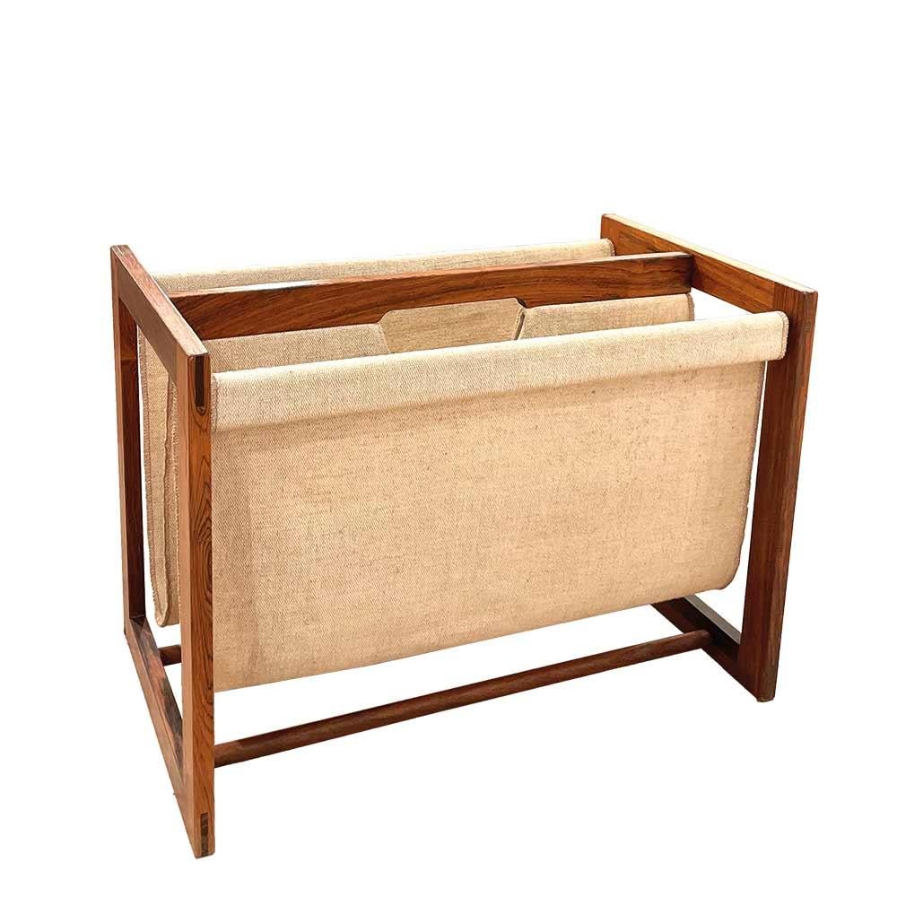 Danish design magazine rack from the 60s with a cubic rosewood structure and double web slings. The heat and beautiful veining of the rosewood gives a lot of style to this magazine rack which offers also a nice storage space. This piece demonstrates