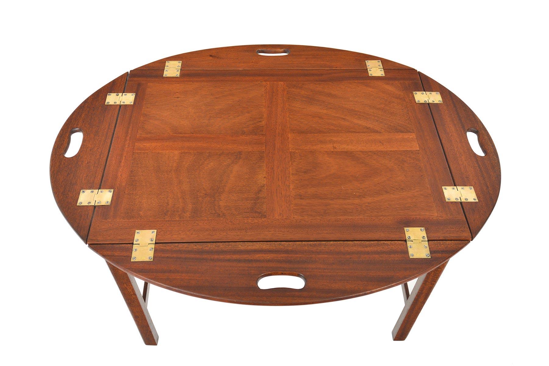 This elegant Danish modern butler’s coffee table is crafted in rich mahogany. The removable tabletop offers hinged sides for convenient travel. In excellent original condition.

   