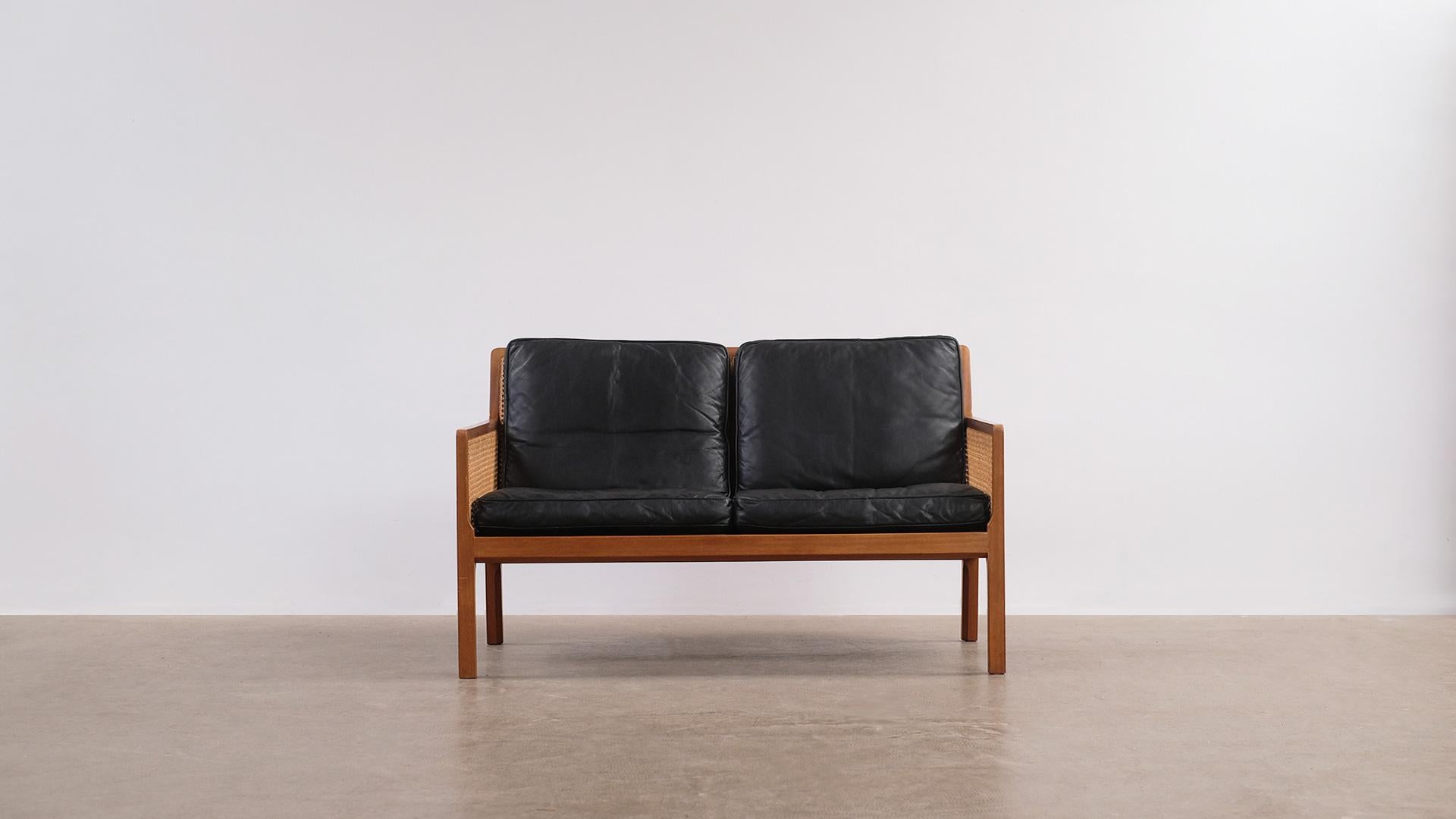 Wonderful sofa in solid mahogany, French cane and leather designed by Bernt Petersen for master cabinet maker Wørts møbelsnedkeri, Denmark. Fantastic craftsmanship, super elegant, simple and Classic design. Buttery soft original leather cushions.