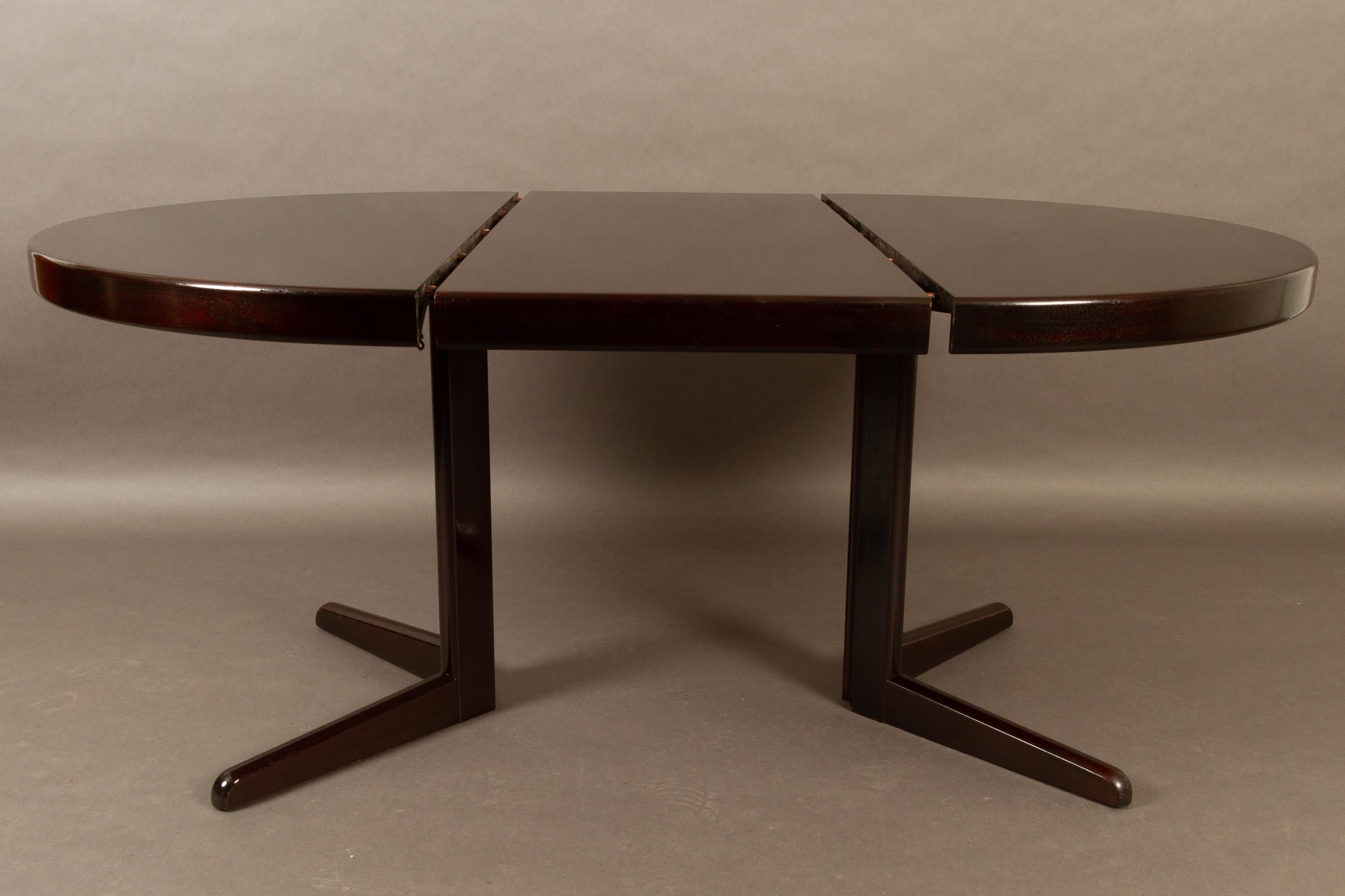 Danish mahogany round extendable dining table by H. W. Klein for Bramin, 1970s.
Elegant round dining table with two extension leaves. Table can be extended up to 215 cm. Dark reddish brown color.
Chairs in photos match this table and are listed as