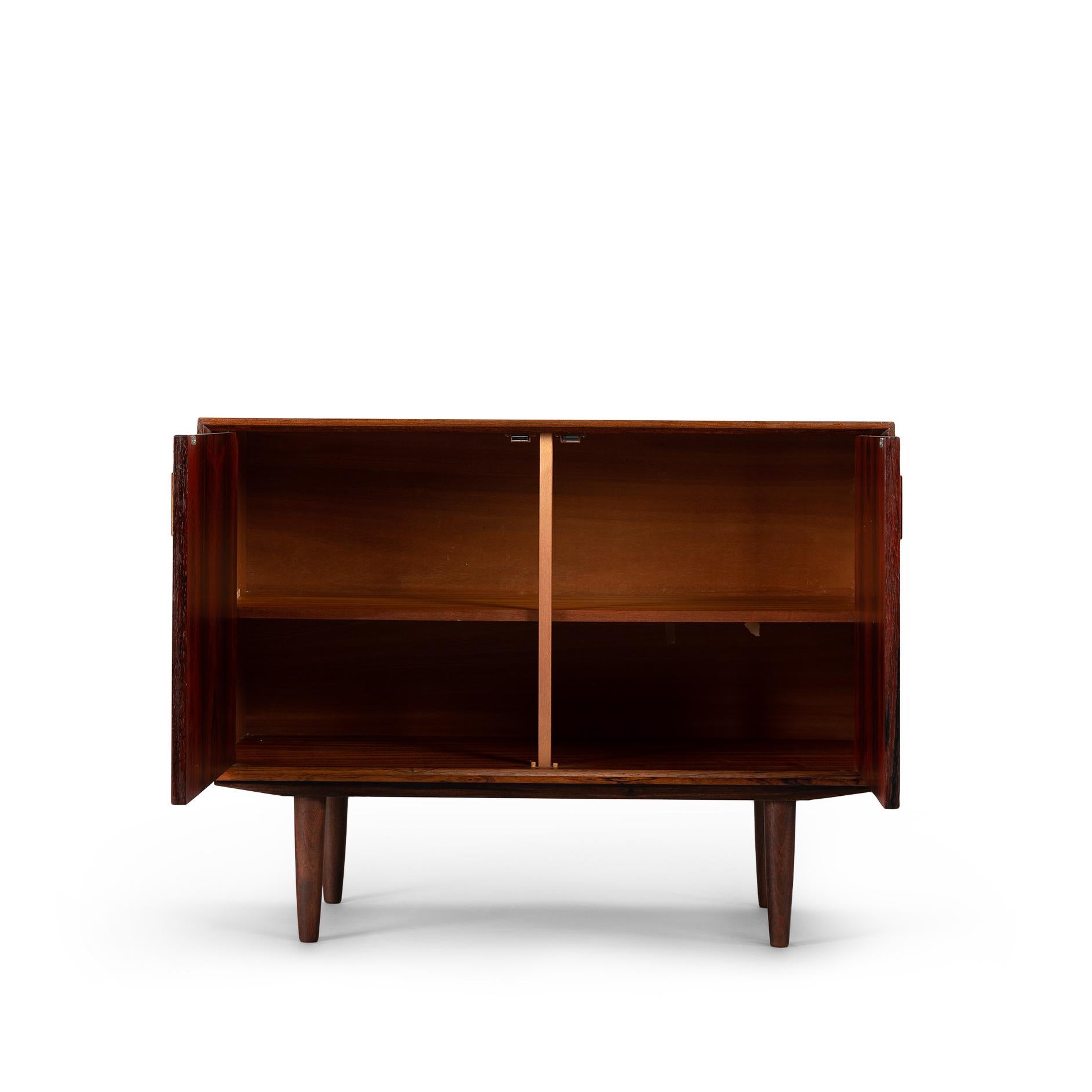 This elegantly designed credenza by Johannes Sorth voor Bornholm Møbelfabrik, clearly marked on the back side of the chest. This sideboard provides for good storage and is made with a nice mahogany veneer. Simple design with only 1 shelve behind the
