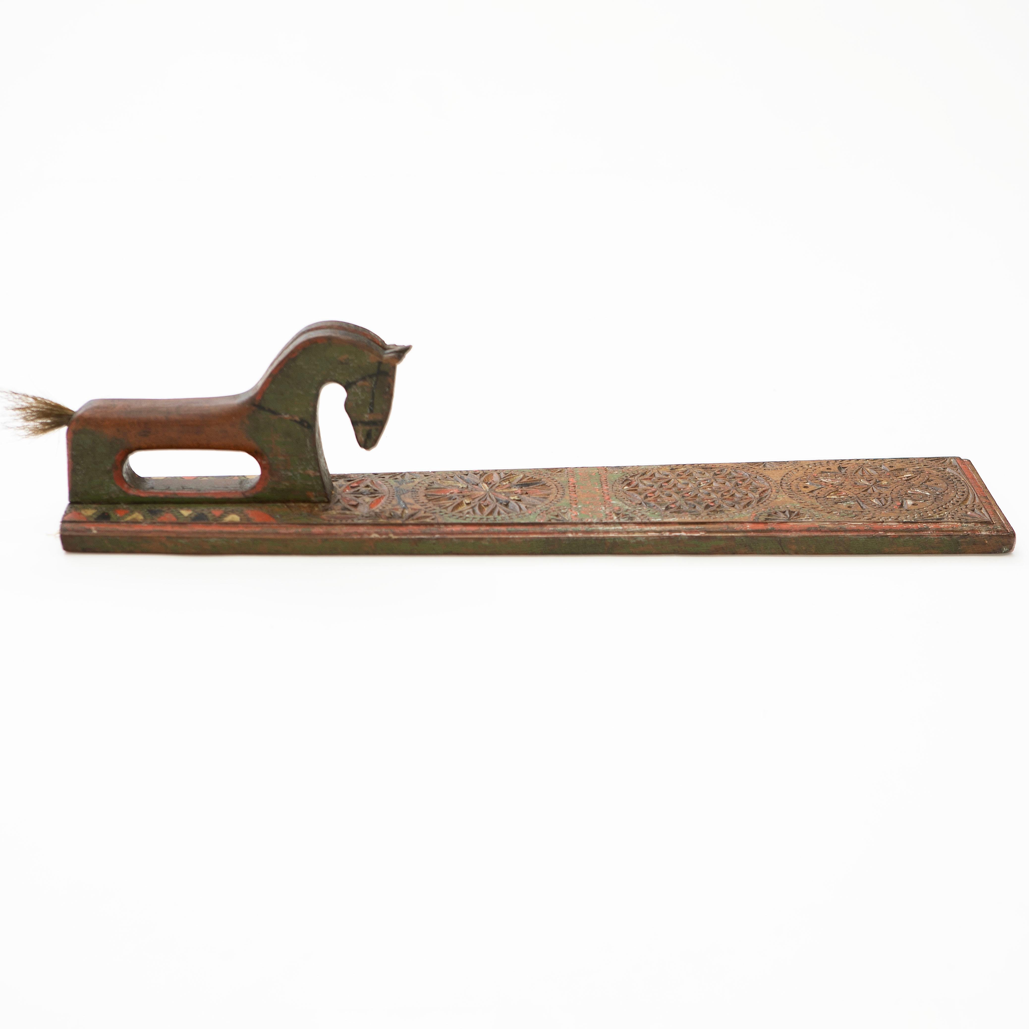 Danish Mangle Board with Horse-Shaped Handles, 1829.
This antique mangle board features handles intricately carved in the shape of two horses, a design that is rarely seen. The board itself is adorned with geometric carvings and retains its original