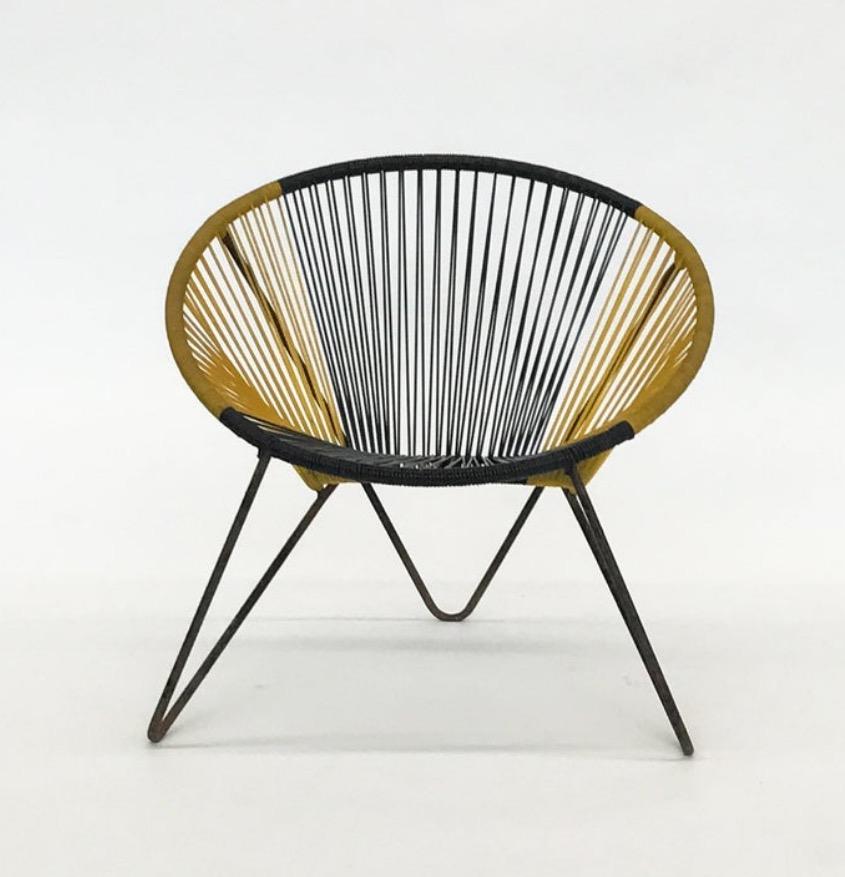 Danish furniture manufacturer: Chair with black lacquered metal frame, stretched with black and yellow plastic strings. Measures: H 67 cm. Traces of wear and rust on the frame.
Style of Acapulco chair.