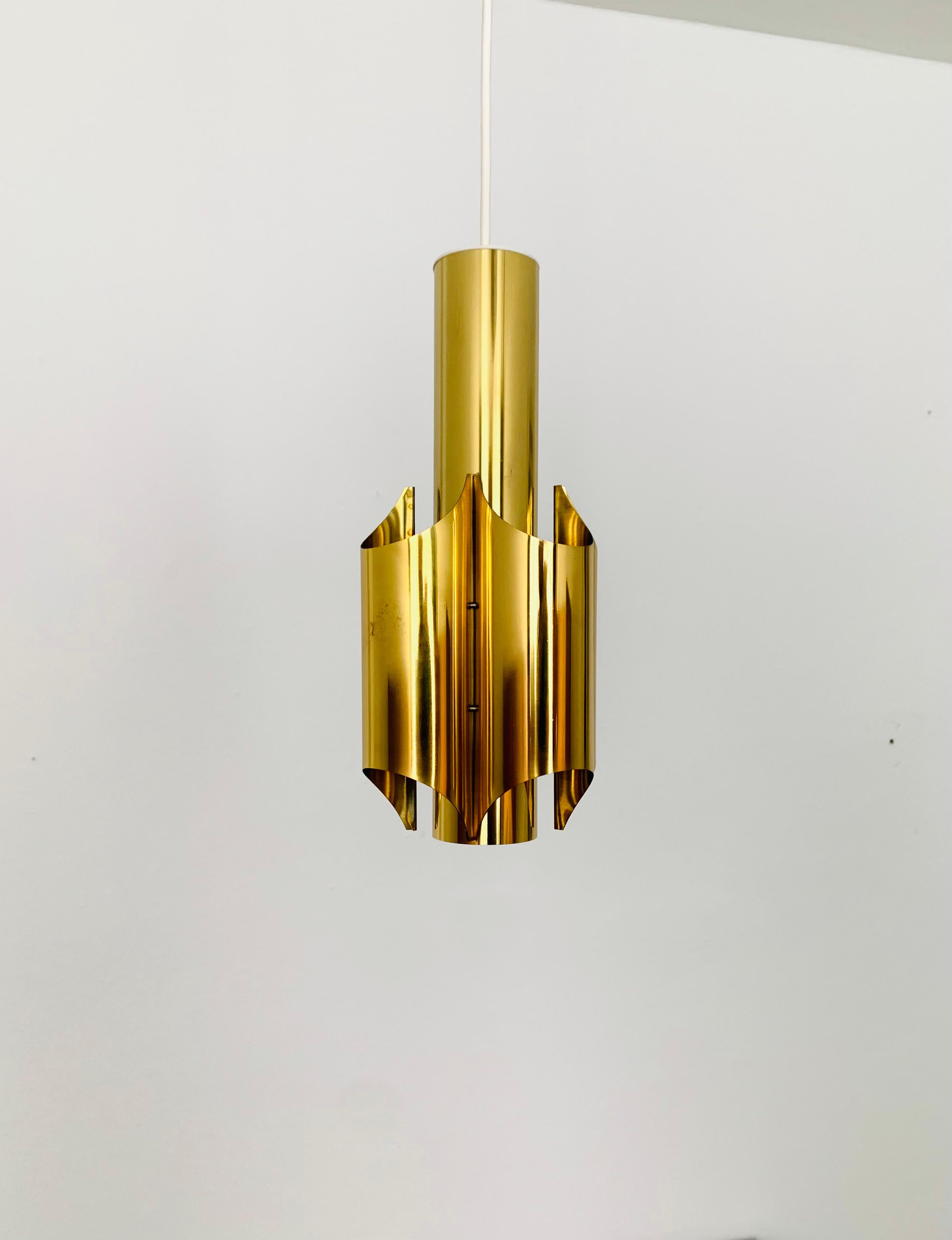 Very nice golden pendant light from the 1960s.
The design and the appearance of the lamp is particularly beautiful.
The shape creates a wonderful light.

Condition:

Very good vintage condition with slight signs of wear consistent with