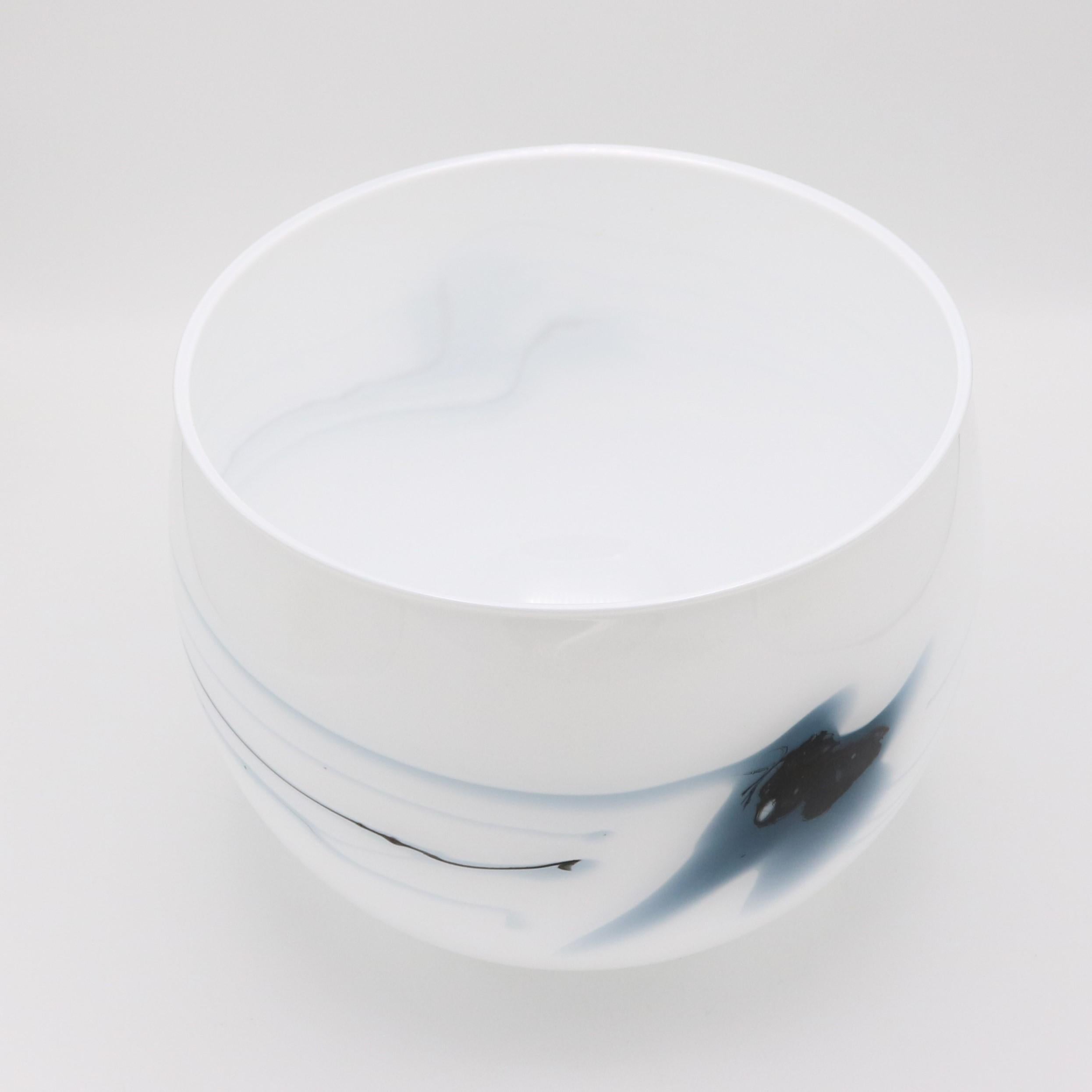 A Holmegaard glass cache pot designed by Michael Bang from Denmark circa 1970. The opaque white glass cache pot (literally “hiding pot” in English) features blue colored swirl patterns with an asymmetrical design. 