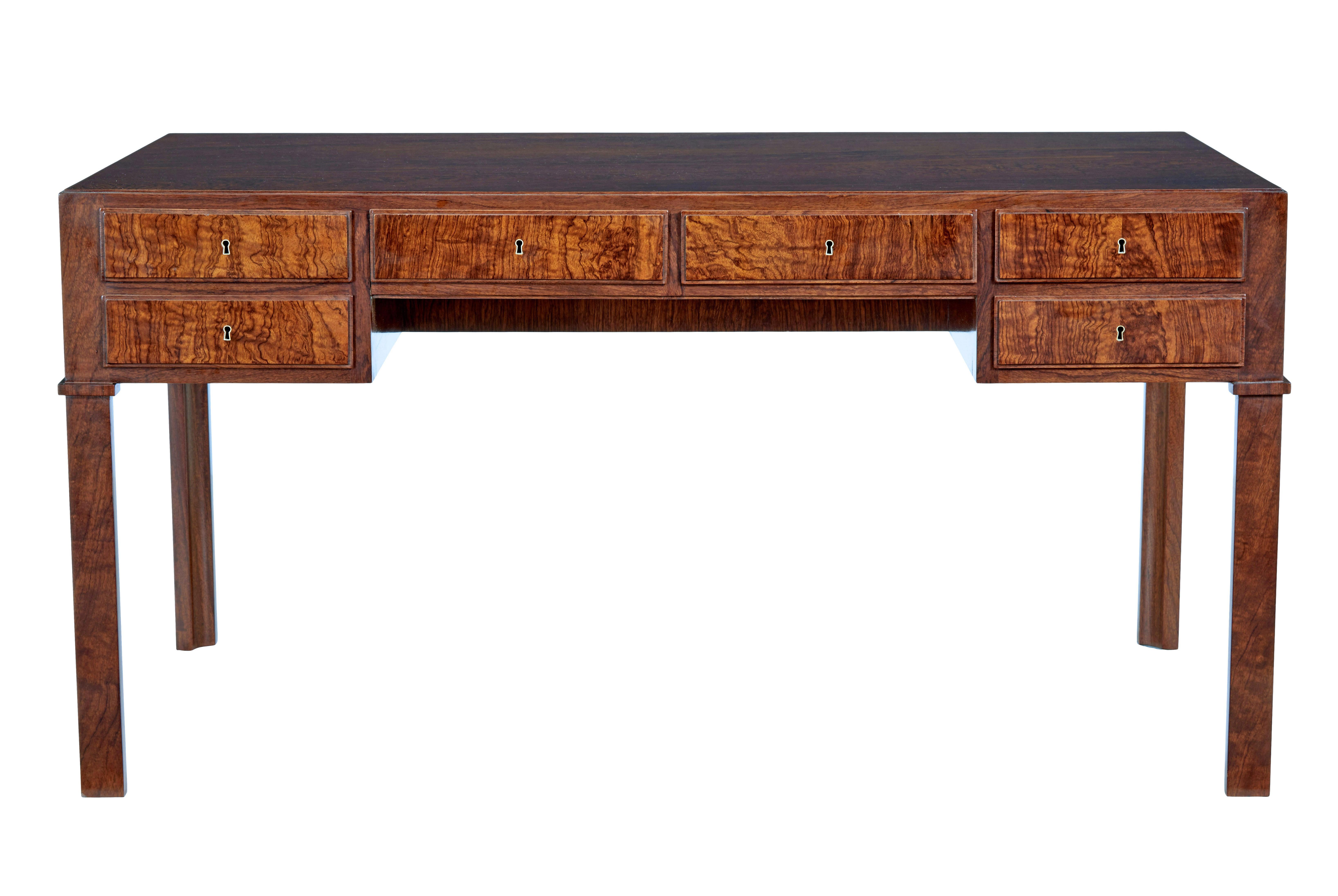 Danish mid 20th century burr walnut desk circa 1950.

We are please to offer this desk which is of the highest quality.

Stunning top with a single veneer covering the whole writing surface.   Veneered to the reverse making this desk free standing. 