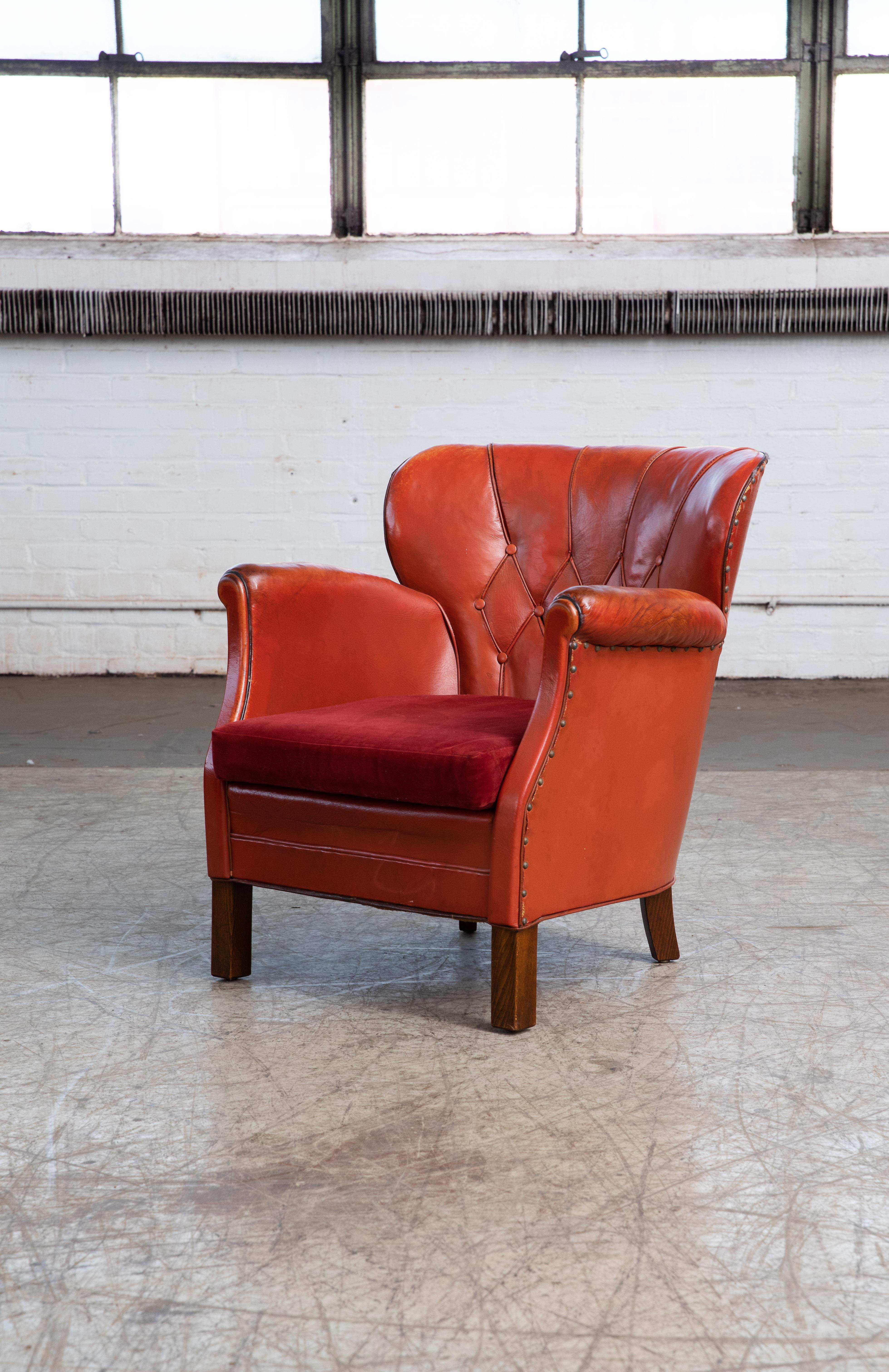 Charming small scale Danish club chair made by Danish furniture maker Oskar Hansen around the mid-1930s. Covered in original red brown leather with a smooth back. Unusually good condition for its age and use with perfect amounts of noble patina and
