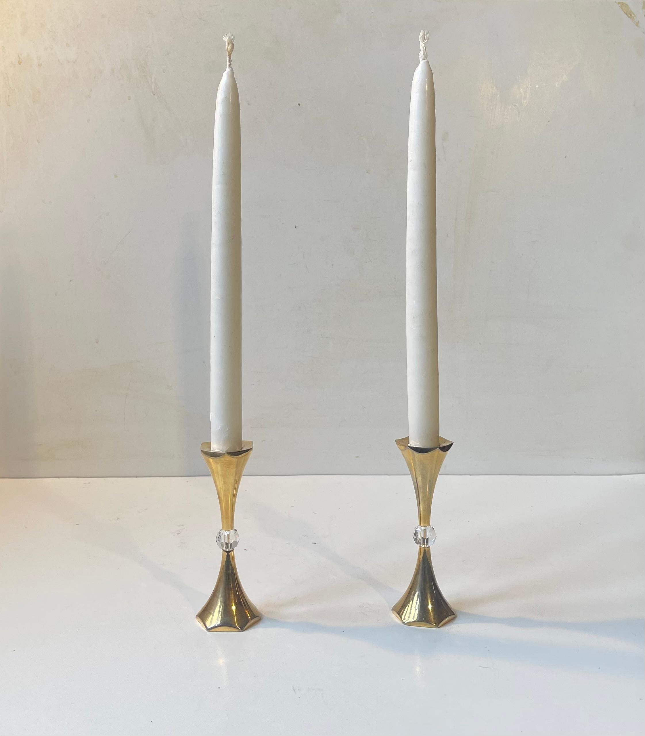 A pair of 24-carat gold-plated candle holders set with faceted crystal beads. Designed by Hugo Asmussen and manufactured at his company Asmussen in Denmark circa 1960s-70s. They are suited for regular sized candles. 

Measurements: H: 12 cm, W/D: 4