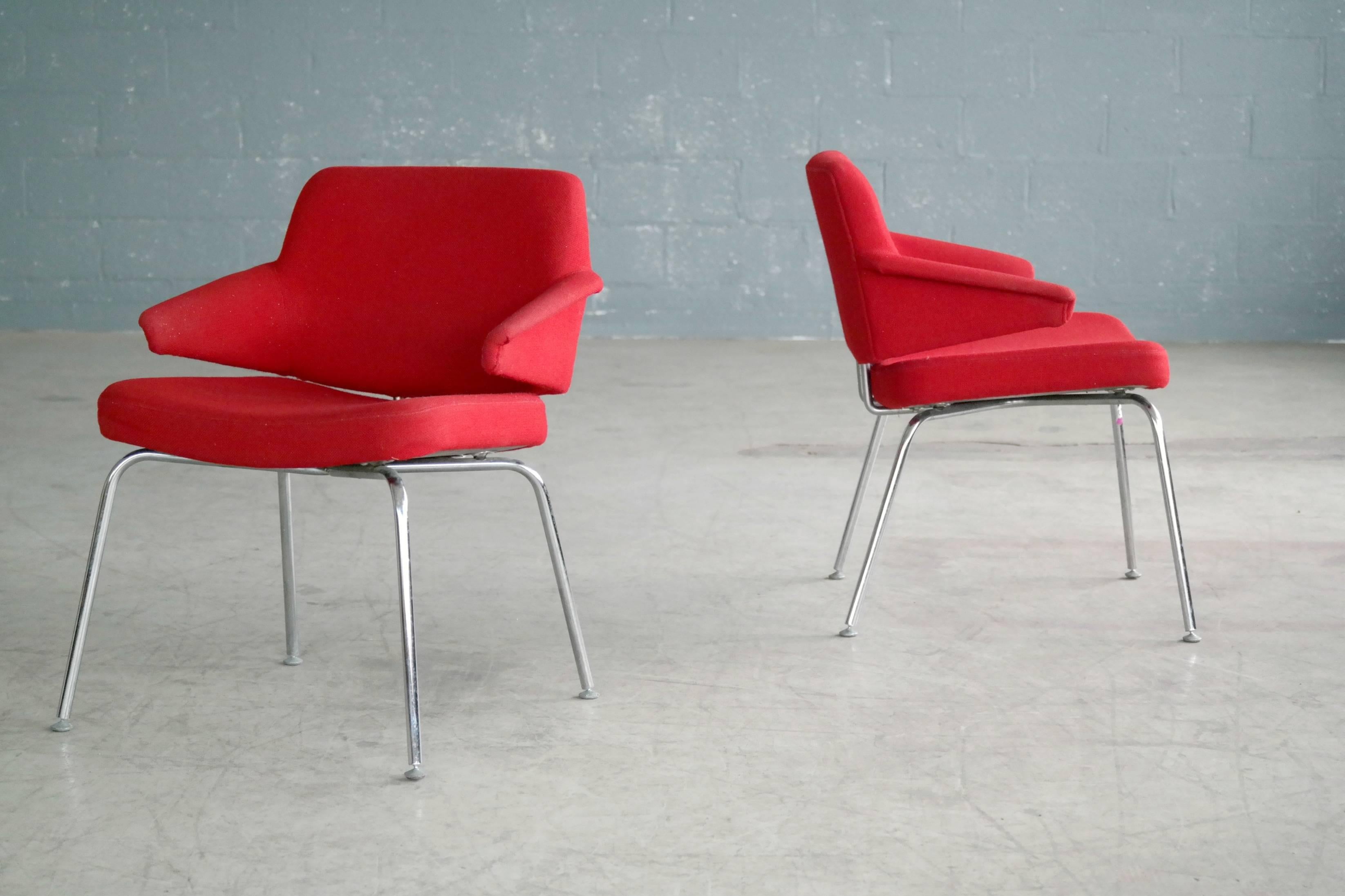 Very cool pair of airport Style easy chairs made by Duba Møbelindustri, circa 1970. Base of chromed steel and still covered in original red wool fabric. Super nice accent chairs full of character. Traces of age and wear but no rust or pitting,