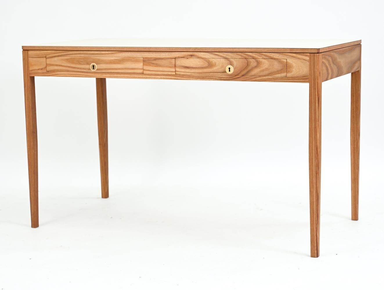 A stylish Danish mid-century desk in ash wood with white laminate top. No manufacturer's labels. 