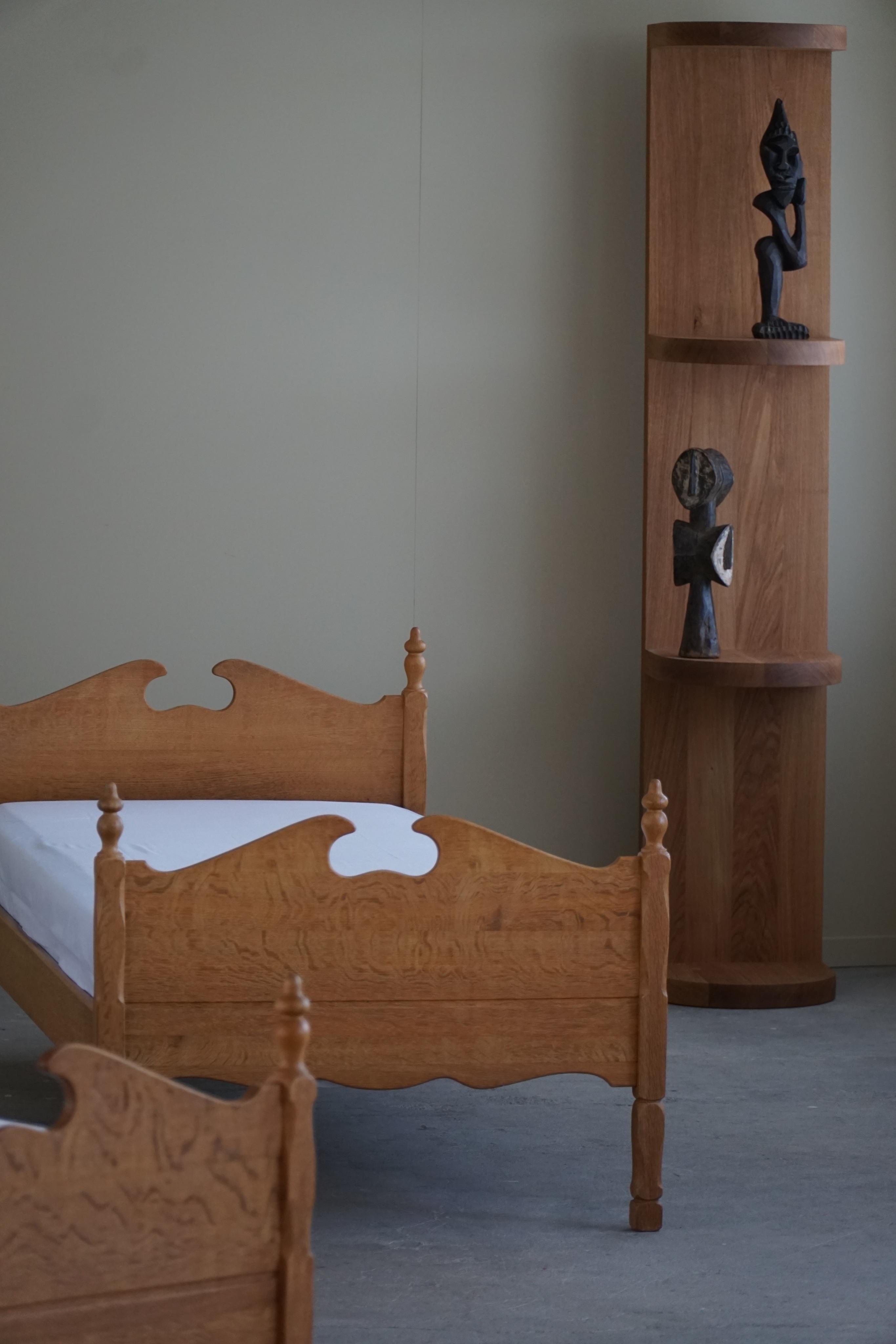 A rare bed in solid oak designed by Thrane & Son. Made in Denmark, 1960s, labeled. 
A sculptural piece that combines Baroque style and modernism. Showing few signs of wear.

Pair available.

This beautiful bed will complement many interior