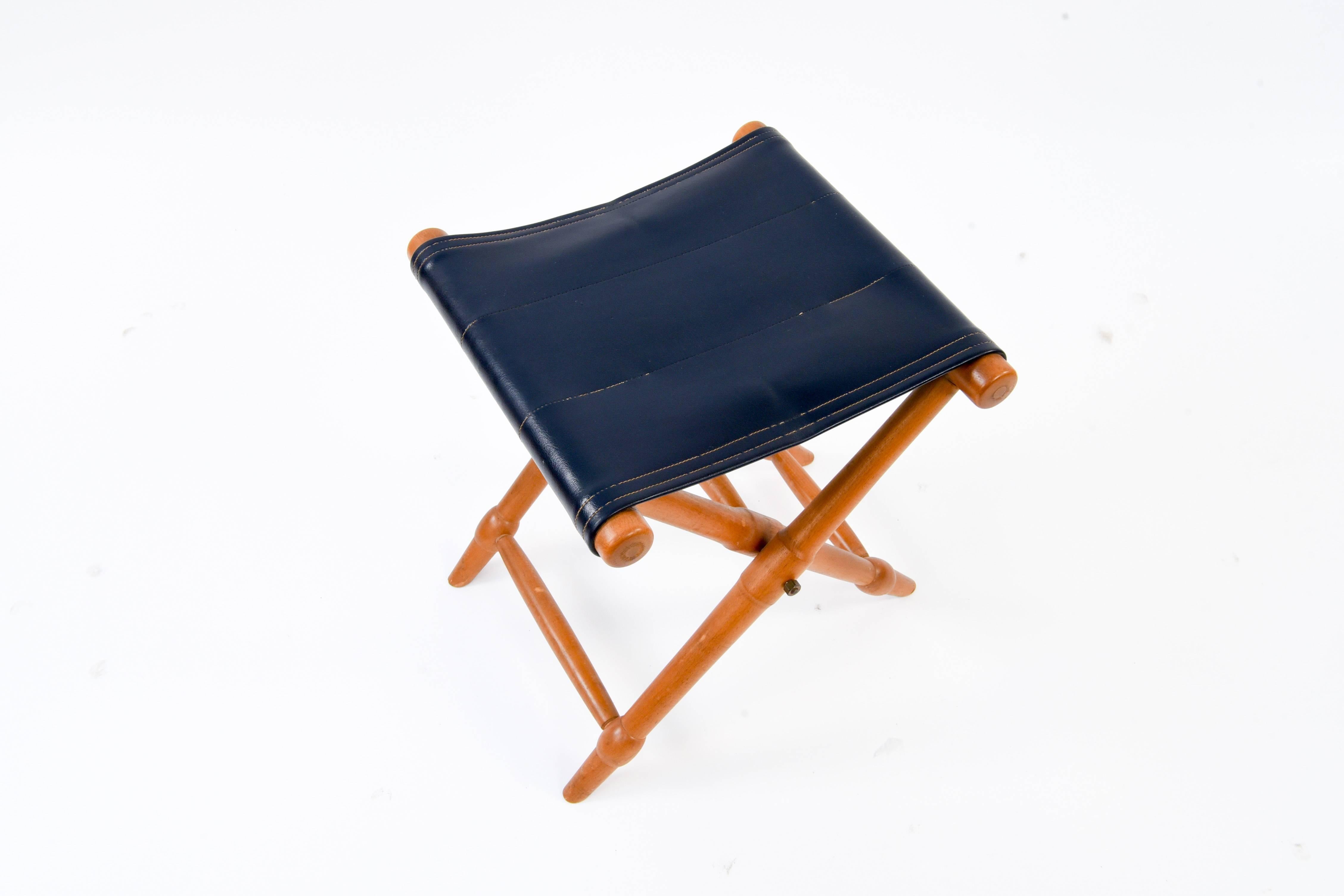 This folding stool features a beechwood frame and leather seat. Danish, midcentury.