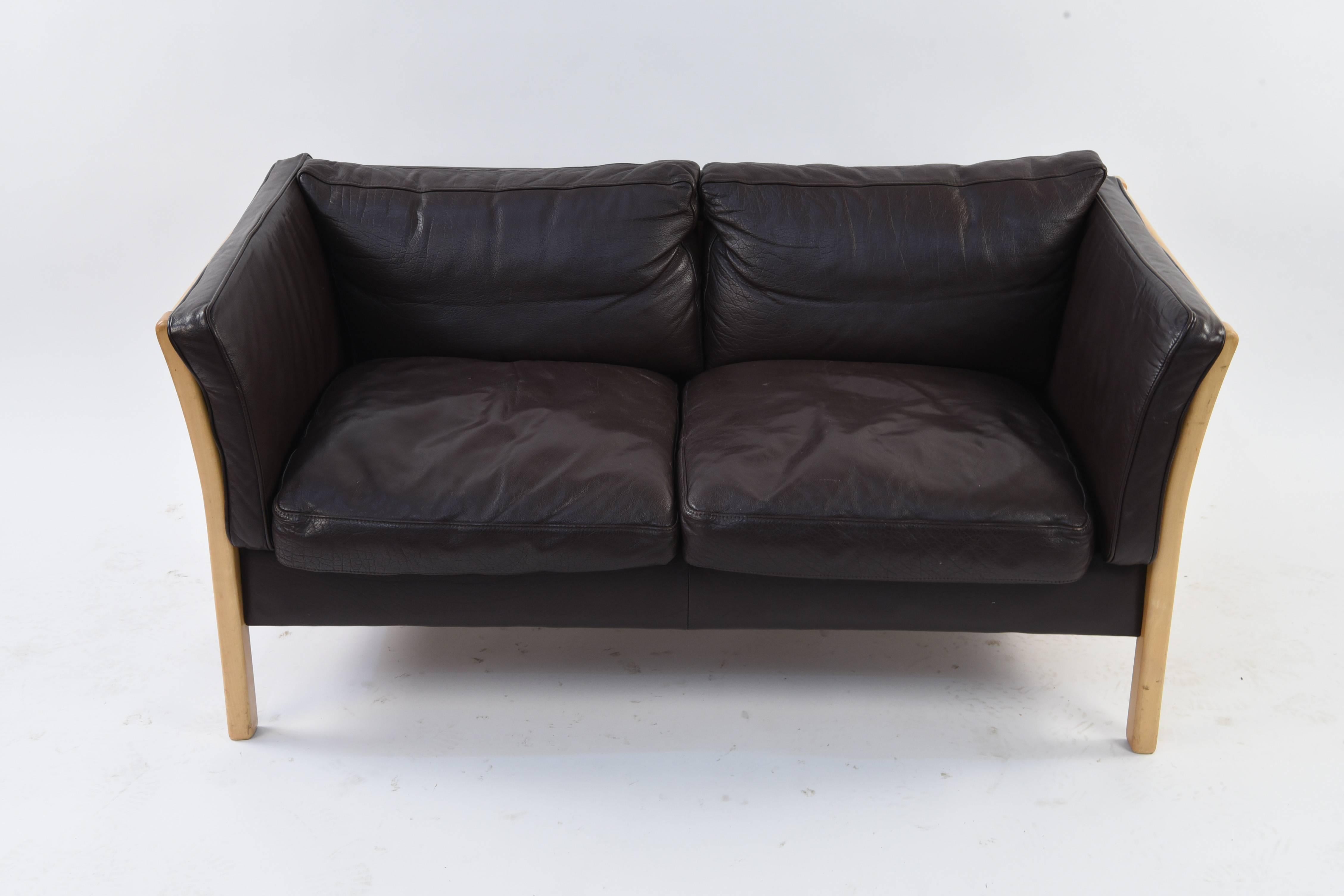 This two-seat sofa or loveseat features beech wood with leather upholstery. Great Danish midcentury look.