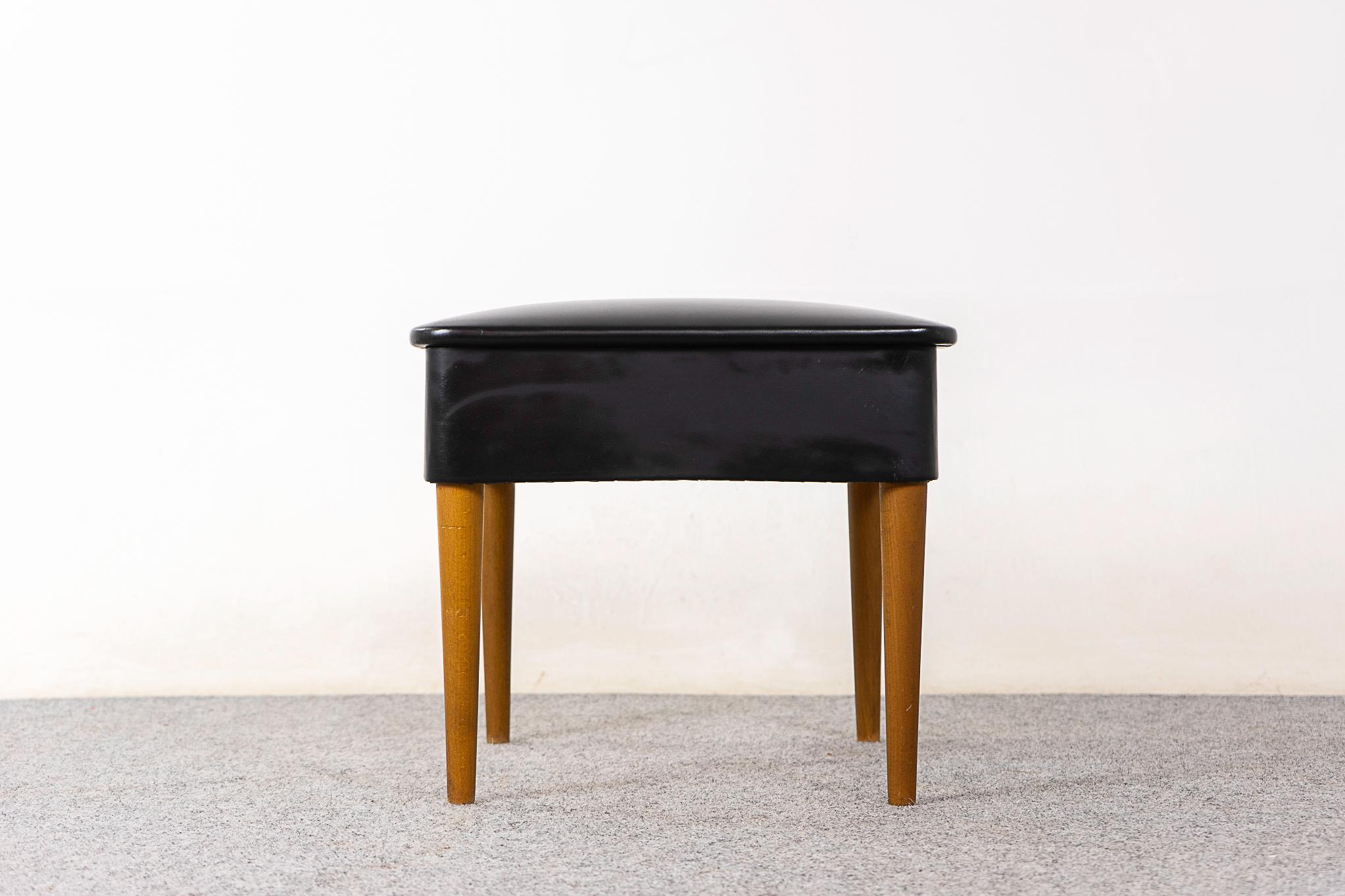 Teak Danish footstool with storage, circa 1960's. Handy flip top divided storage compartment. Tapering, sleek removable legs and original vinyl upholstery. 