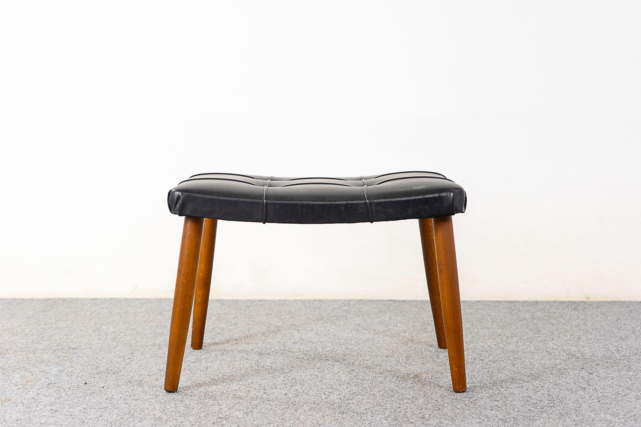 Danish beech footstool, circa 1960's. Sleek tapering legs and original upholstery with wear.