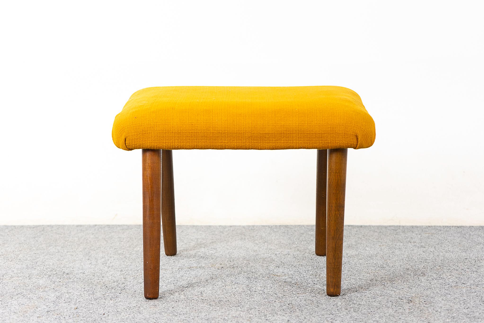 Beech Danish footstool, circa 1960's. Angled profile with tapering legs and original upholstery with wear.  