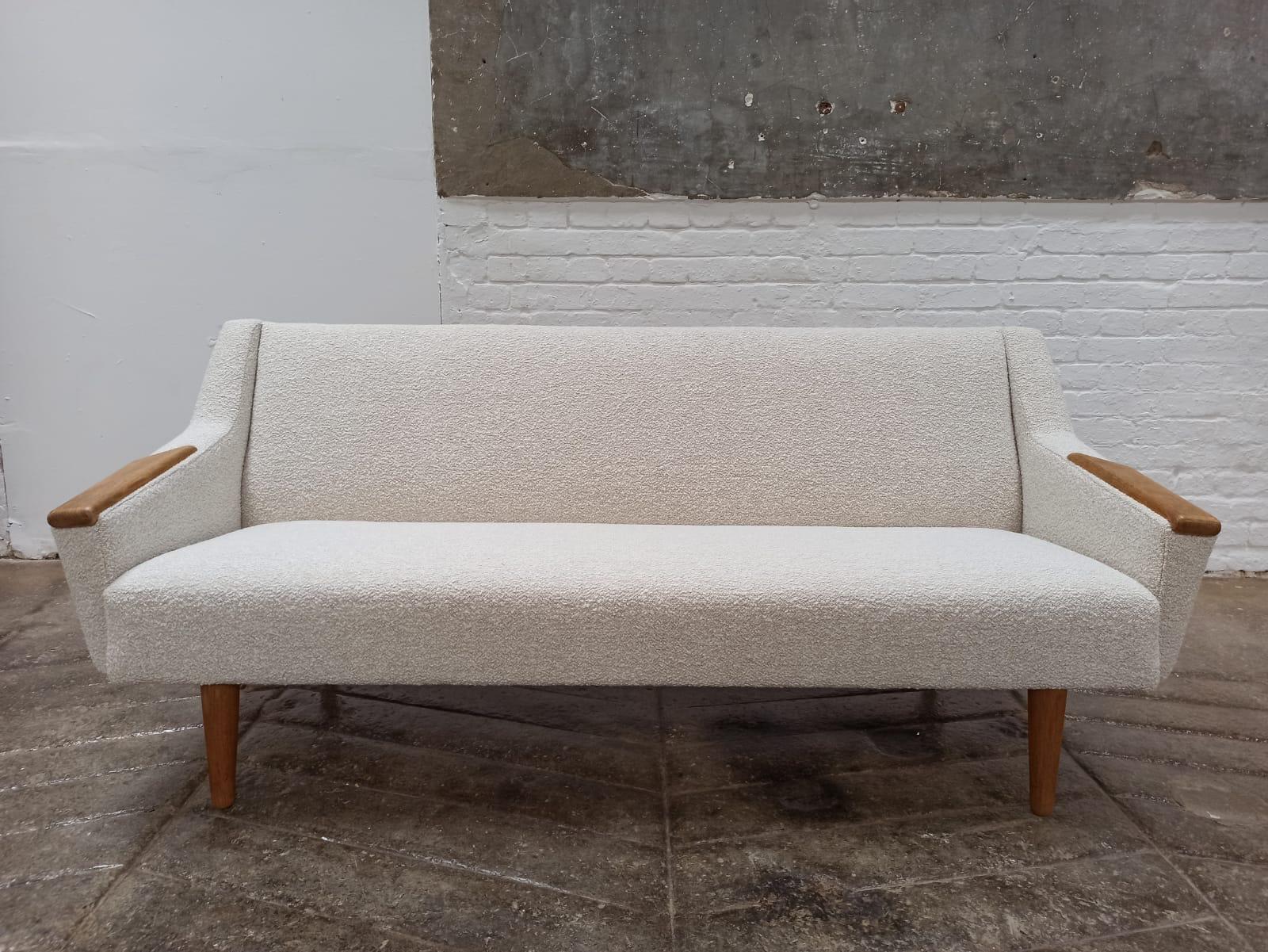 Danish mid-century sofa, this fabulous refined design typical of the time. Smart teak armrests are a real feature a particular and unique design, with elegant tapering leg. This sofa has been professionally reupholstered in a high quality wool