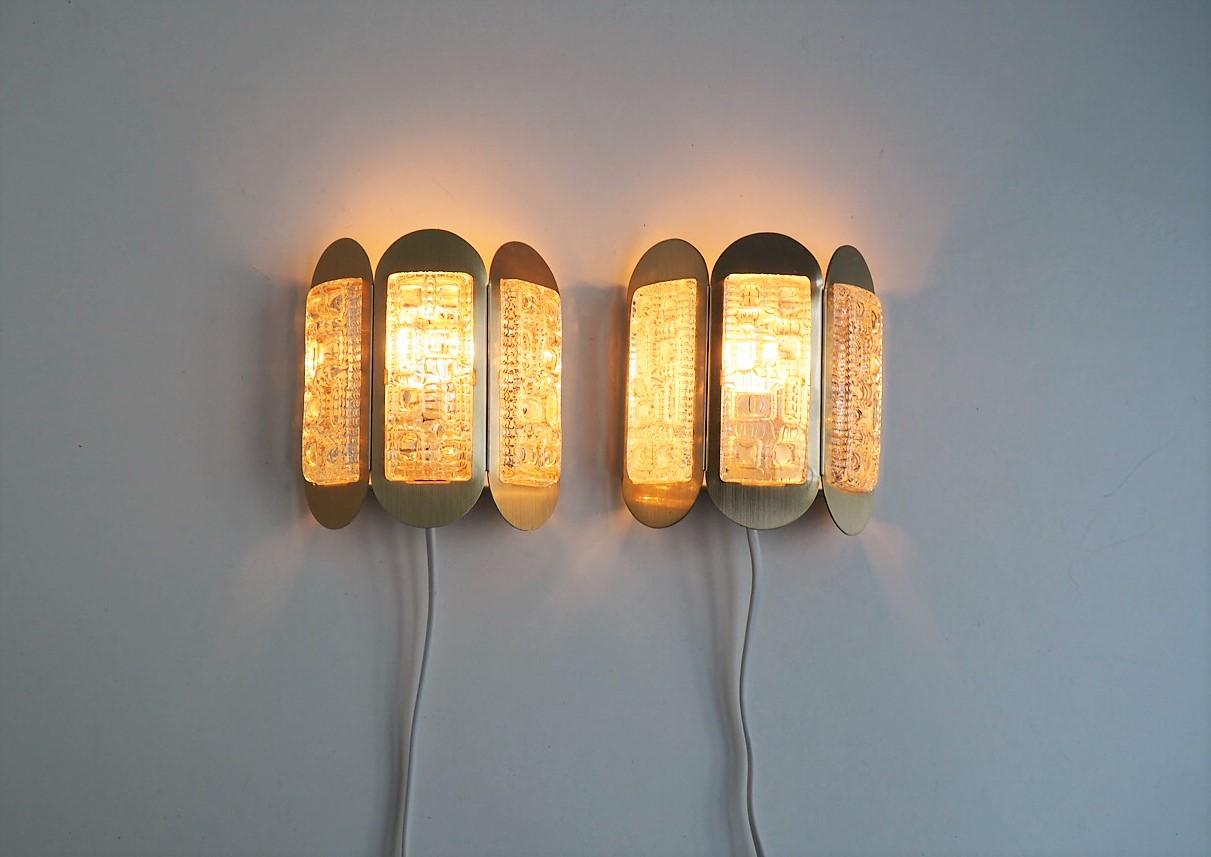 Pair of Danish midcentury brass colored sconces in combination with thick decorative glass pieces made in the 1960´s.

They are made by the Danish company Vitrika in the 1960´s. Vitrika was a lamp manufacturer with a very large repertoire, and it