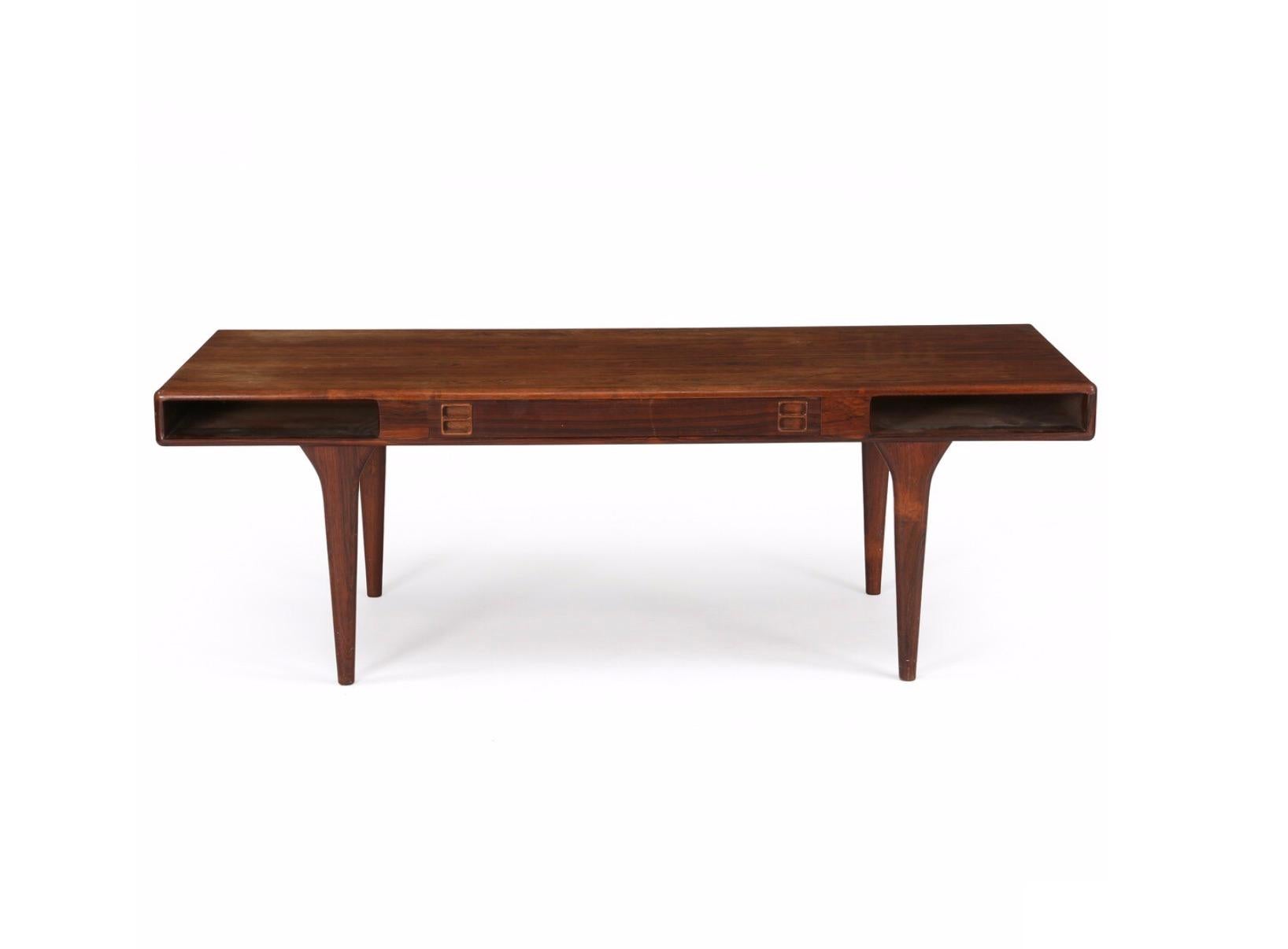 Rectangular Brazilian rosewood coffee table. Rail with drawers and shelves. Manufactured by CFC Silkeborg, with maker's metal tag. CFC Silkeborg, Denmark/ Presumably Jørgen and Nanna Ditzel.



