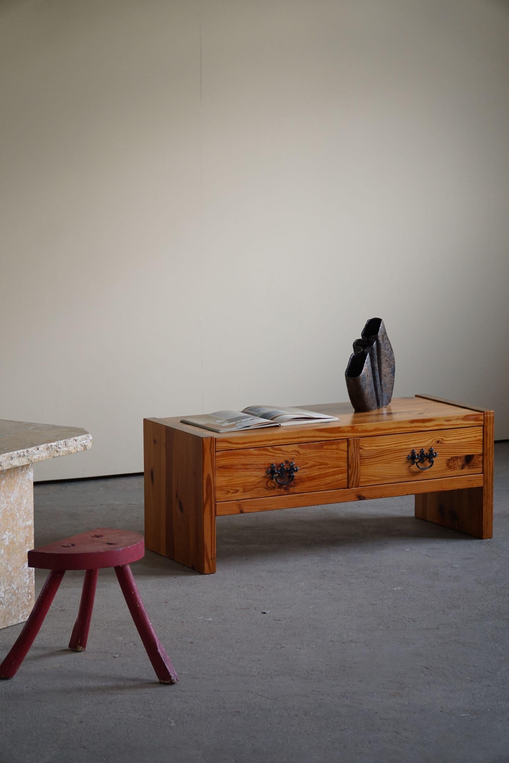 Low rectangular commode in solid pine and forged iron. Made in 1970s in Denmark. Unknown cabinetmaker.

A great patina in good vintage condition.

With a heavy focus on functionality, this design style leans toward modernism, while incorporating