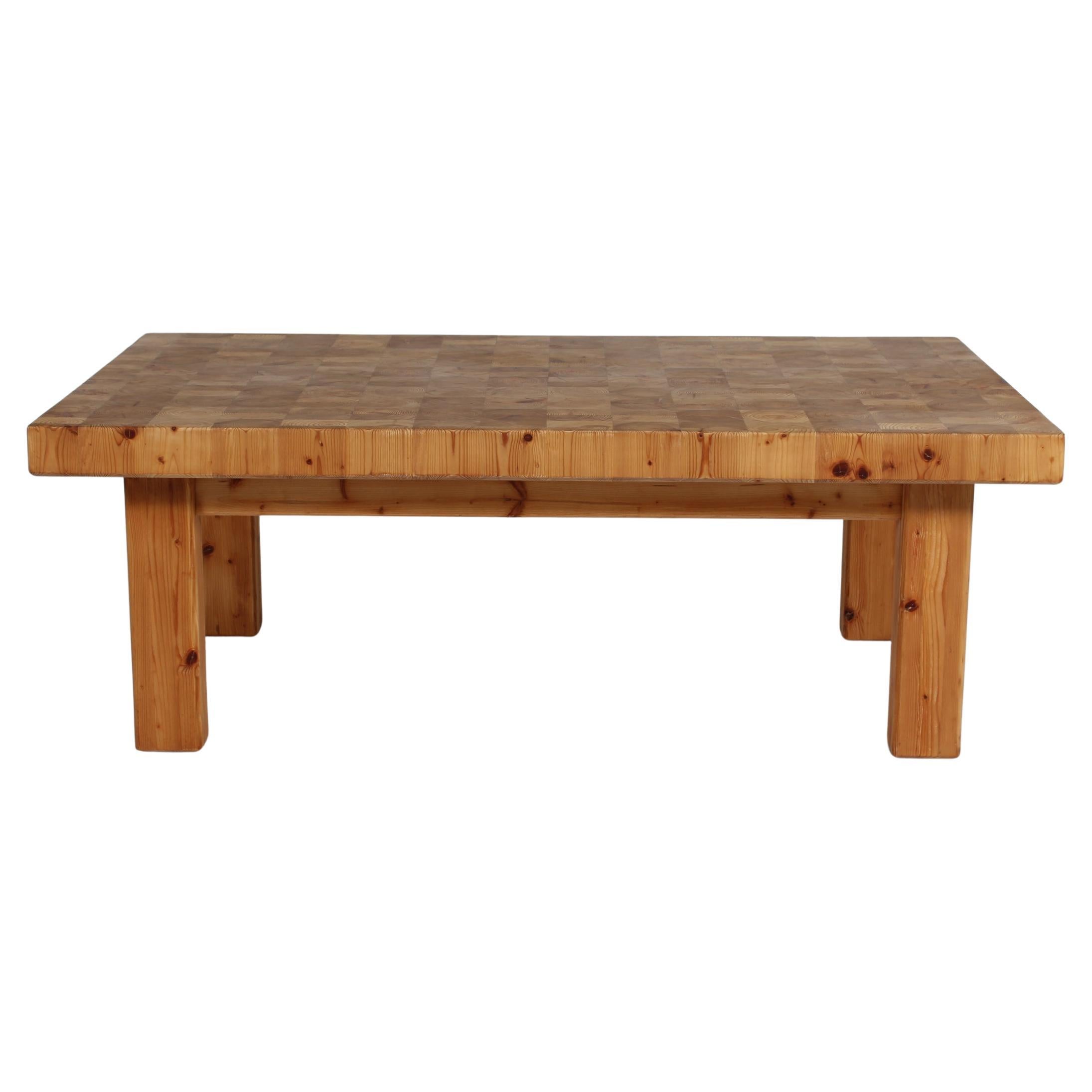 Danish rustic brutalist style rectangular sofa table of solid pine with a heavy tabletop on four rectangular robust legs.
Manufactured by a Danish cabinetmaker in the 1970s. 

The fine natural surface and patina with a warm glow has slowly been