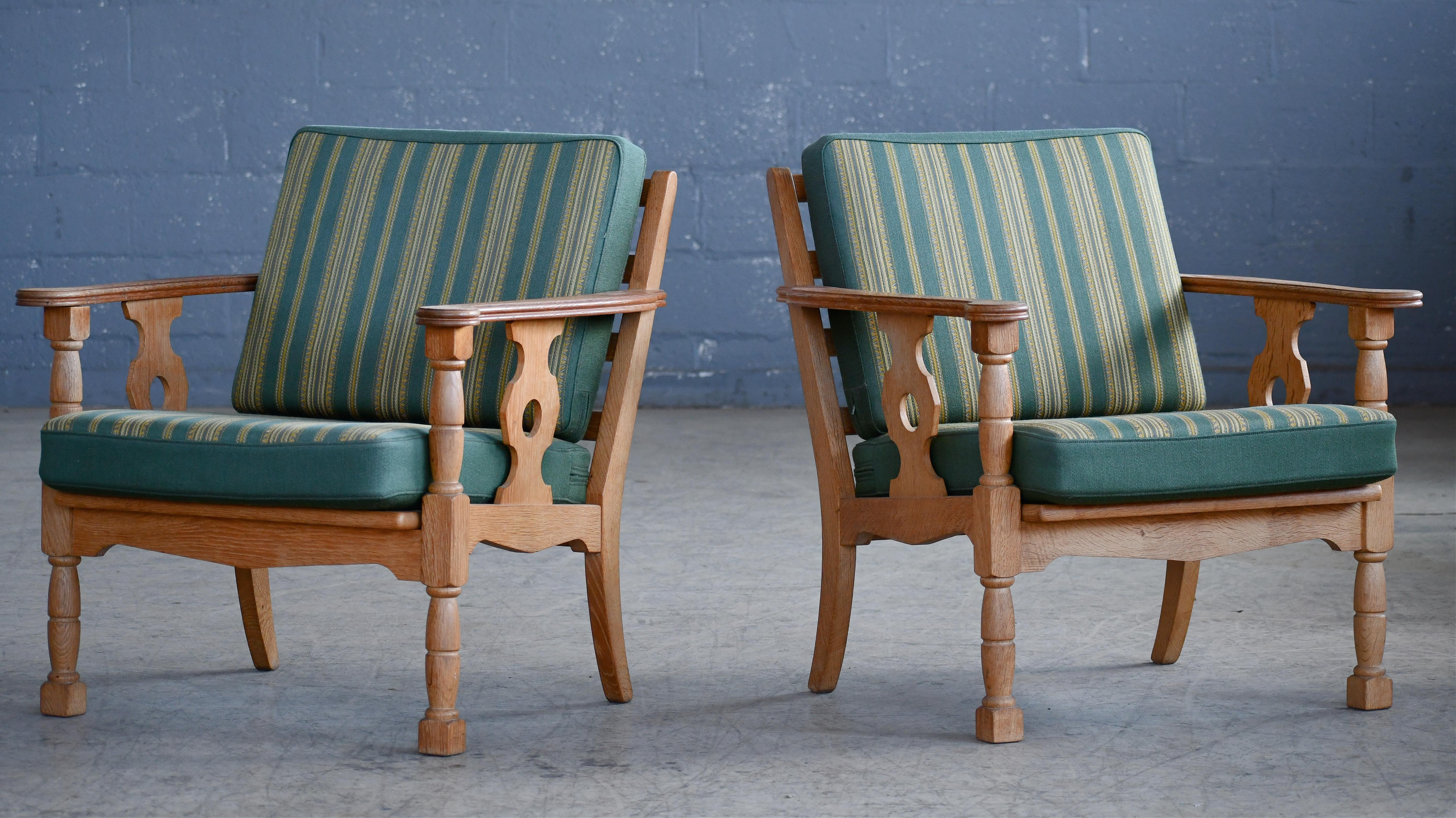Very cool sought after pair of  easy chairs by Danish Designer, Henning (Henry) Kjaernulf made from quarter-sawn white oak and hand carved in a brutalist style inspired to art & crafts and even Jacobean styles. Kjaernulfs style is very unique and