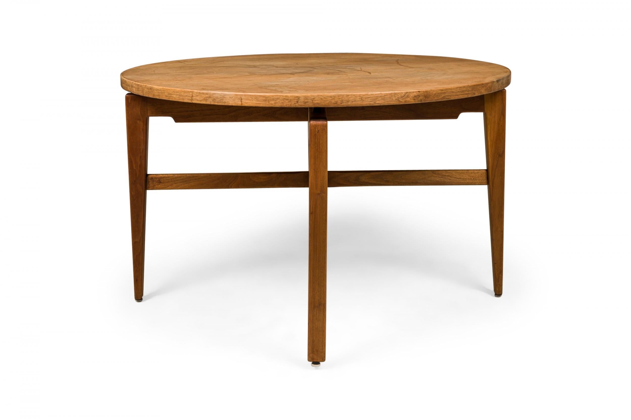 Danish Mid-Century circular walnut dining table with a rotating lazy susan top resting on an X-shaped walnut base with tapered square legs. (JENS RISOM)(Similar tables: DUF0276, DUF0277, DUF0279)
