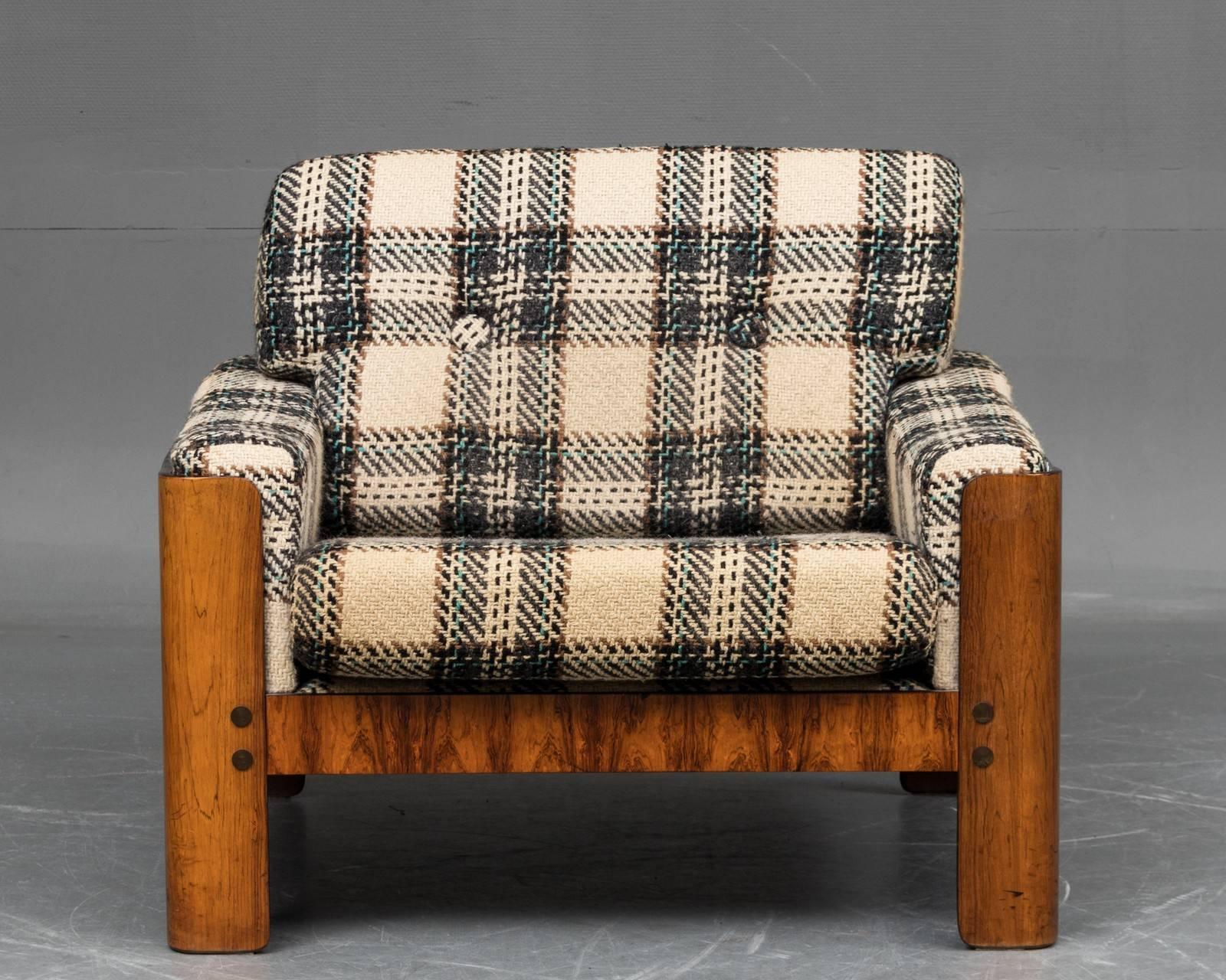 Very charming and rare easy chair attributed to Designer Arne Wahl Iversen for Komfort Mobler of Denmark, circa 1970. Nice wool covered cushions showing minimal wear in a time typical checkered pattern on frames of Brazilian rosewood veneer. The