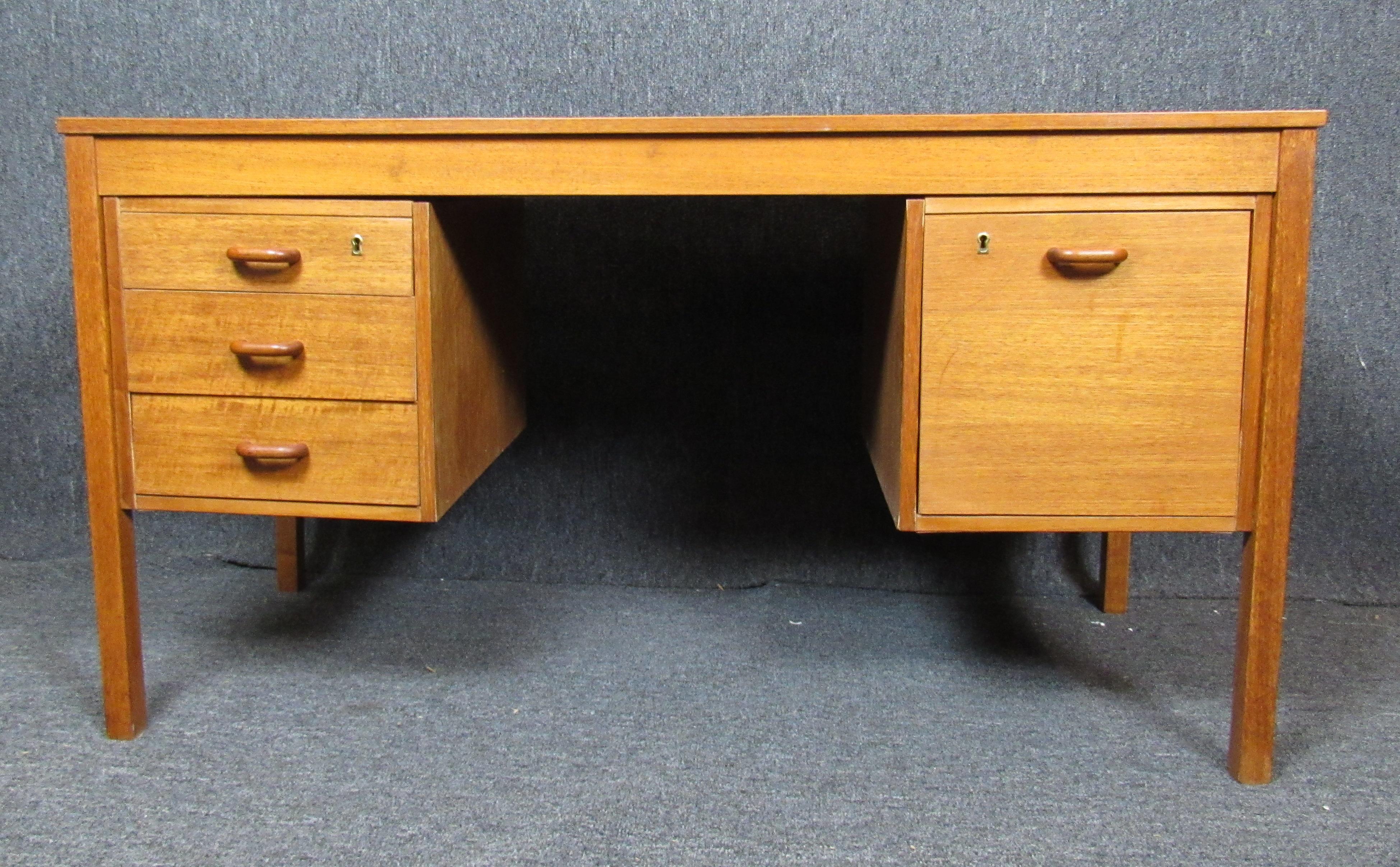 Mid-century modern office desk with two banks of drawers. Danish made teak wood desk for home or office use.
Please confirm location NY or NJ
