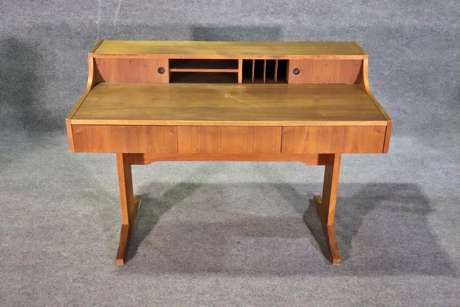 This vintage writing desk made in Denmark features three drawers and plenty of small storage compartments. This desk is normally in a rosewood, so this item is a rare find.
Please confirm location NY or NJ