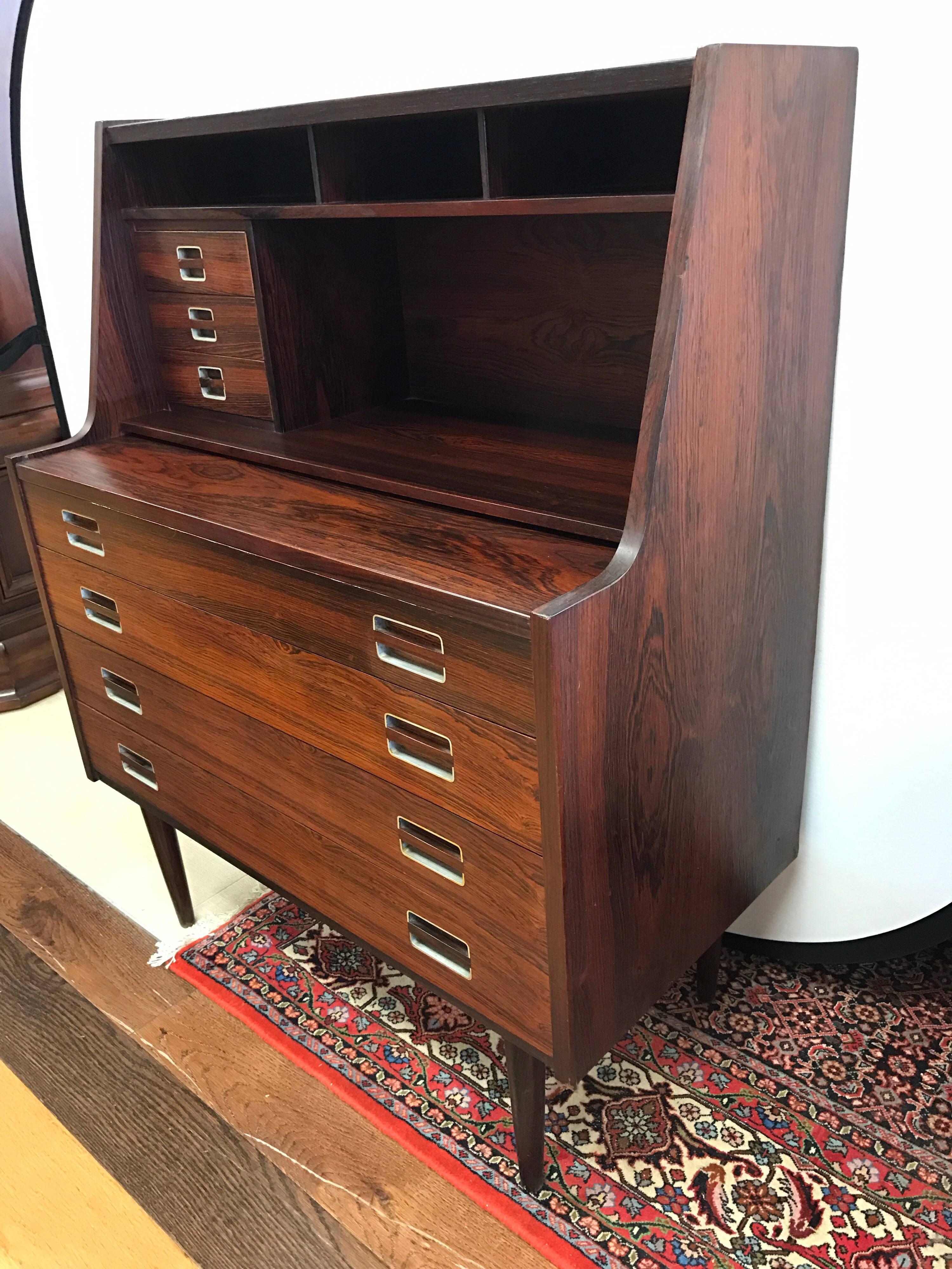 Bureau de secrétaire ou meuble-lavabo en bois de rose de style scandinave moderne:: doté d'un tiroir supérieur qui se retire pour servir de surface d'écriture ou qui se relève pour révéler un miroir. La partie supérieure comporte trois petits