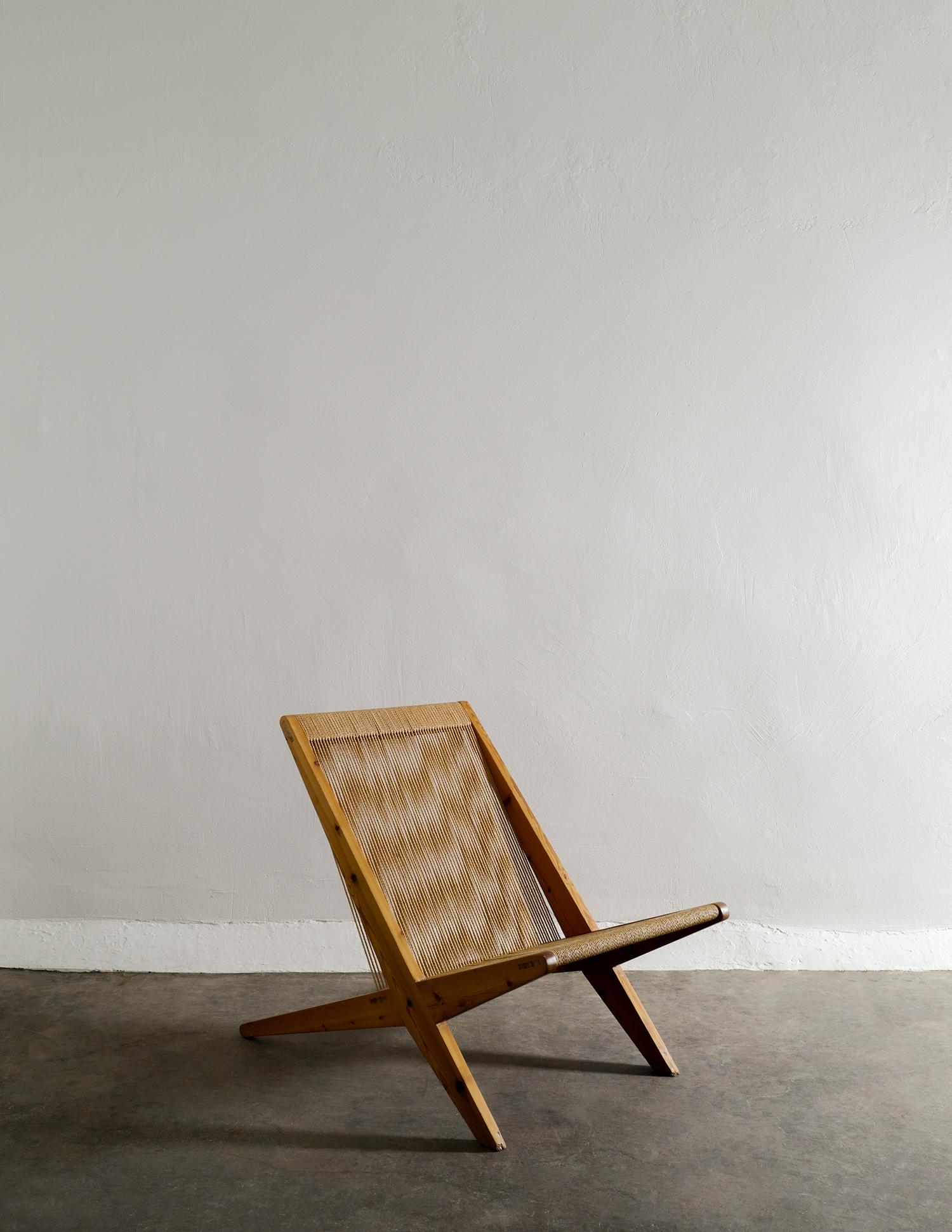 Very rare armless mid century easy lounge chair in pine and papercord in style of Poul Kjærholm and Jørgen Høj produced in Denmark in the 1960s. In good vintage and original condition with patina from age and use. No breaks or damages in the