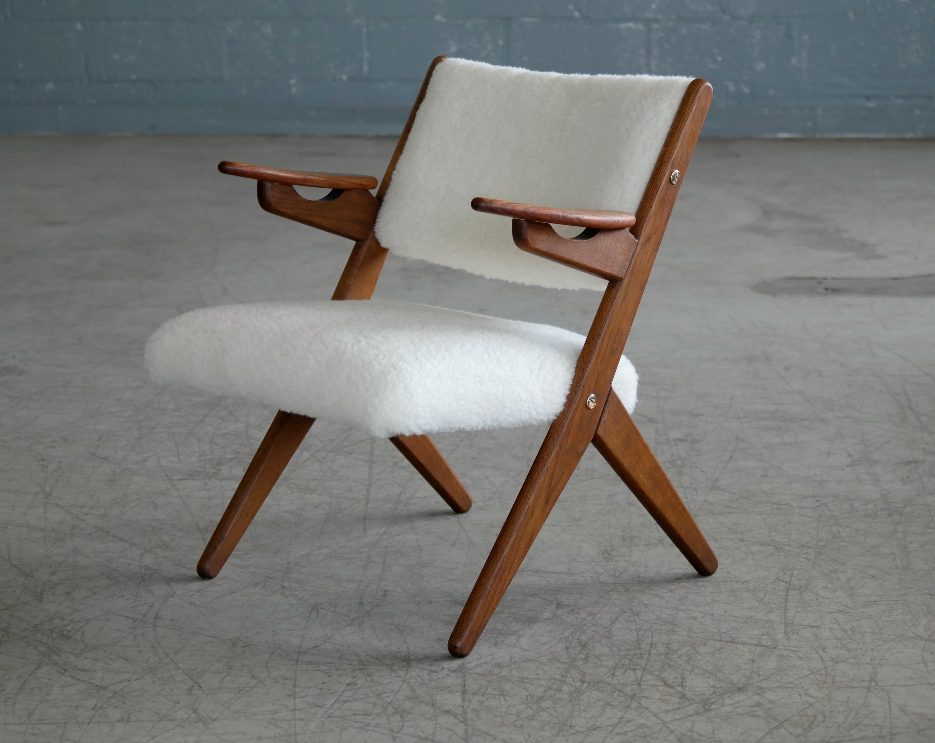 Sculptural and very beautiful 1950s easy chair made from solid teak with nice grain and color designed by Danish Designer, Arne Hovmand-Olsen. The wood frame shows appropriate age wear with minor scuffing and scratches and patina and surface wear on