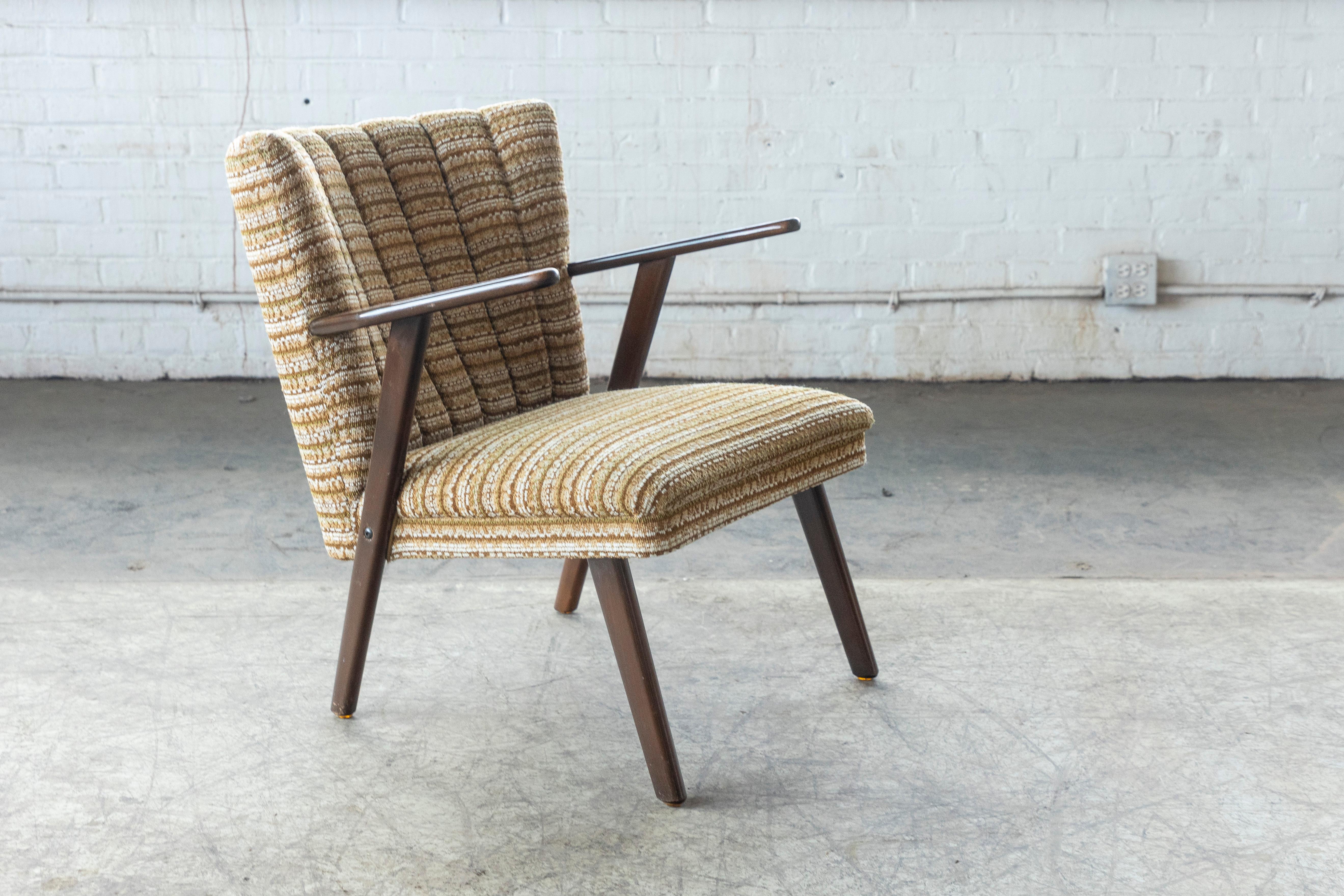 Very cool Danish mid-century armchair in stained beech covered in wool and very representative of the easy chairs of the time designed by such icons as Arne Vodder and Hans Wegner. Frame is built into the seat and made from solid beech. Solid and