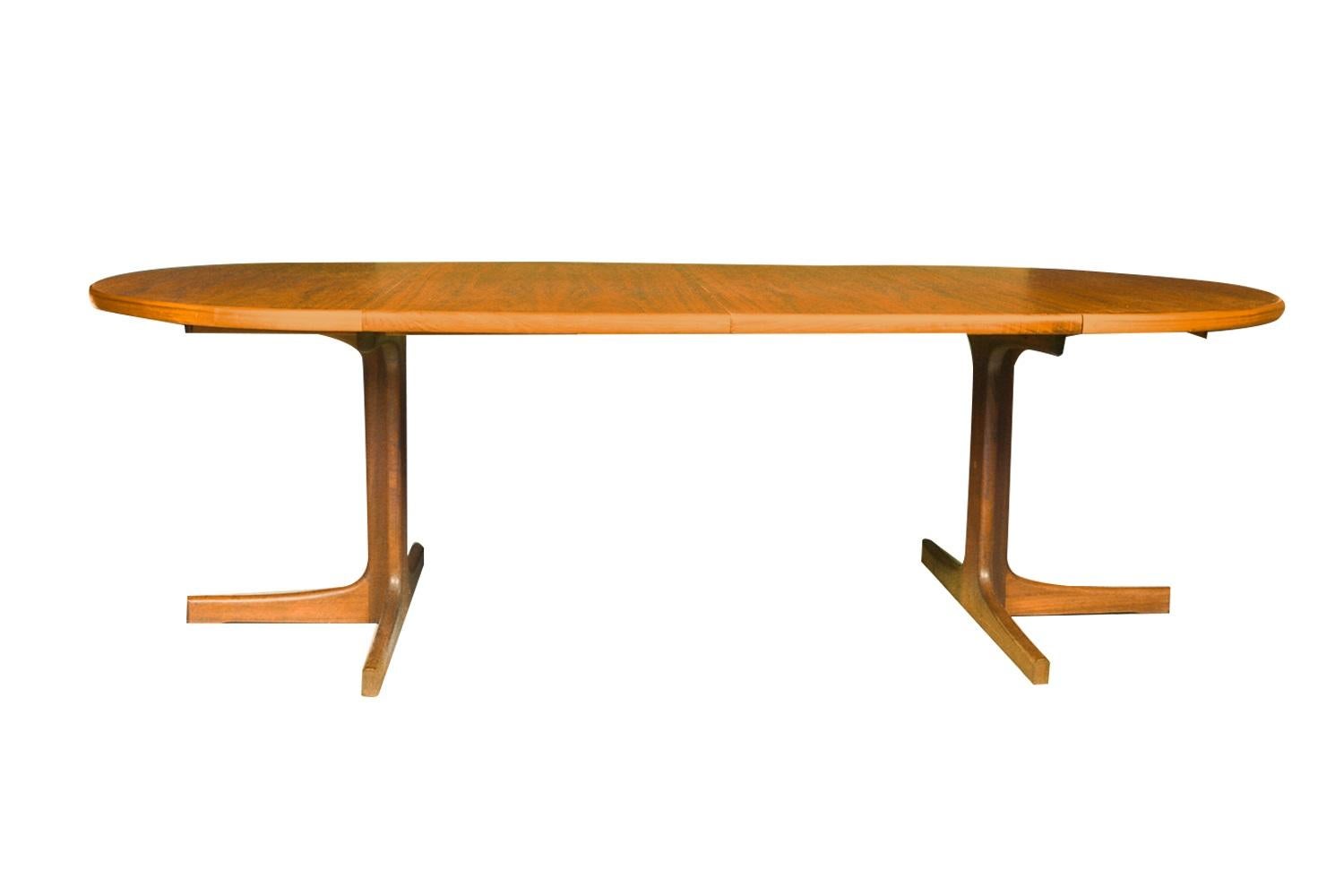 Beautiful Mid-Century Modern expandable round dining table designed by Niels Koefoed for Koefoeds Hornslet, model “Lis” made in Denmark, circa 1960s. This stunning teak dining table features richly grained, gleaming teak and smooth, clean lines