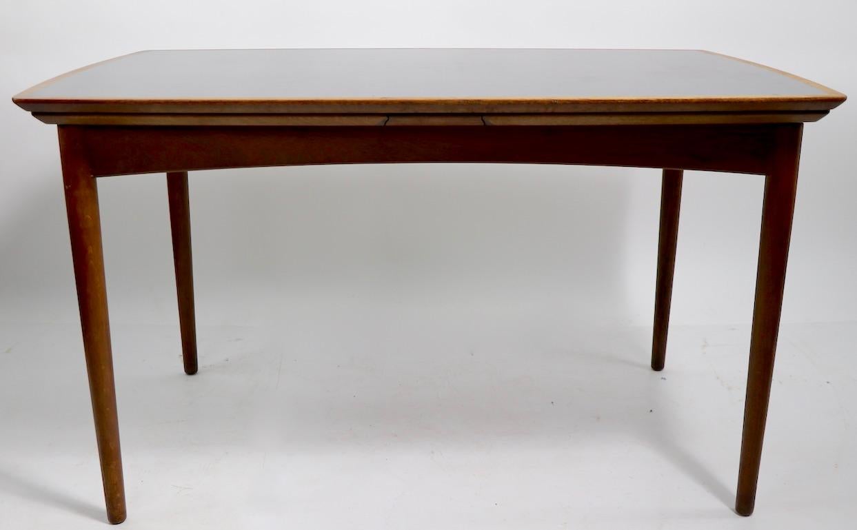 Exceptional extension dining table marked Mills custom furniture from Denmark 222 East 56 st New York 22 NY. This interesting table has a refractory style top, with leaves that store under the top and extend from each end rather than place in the