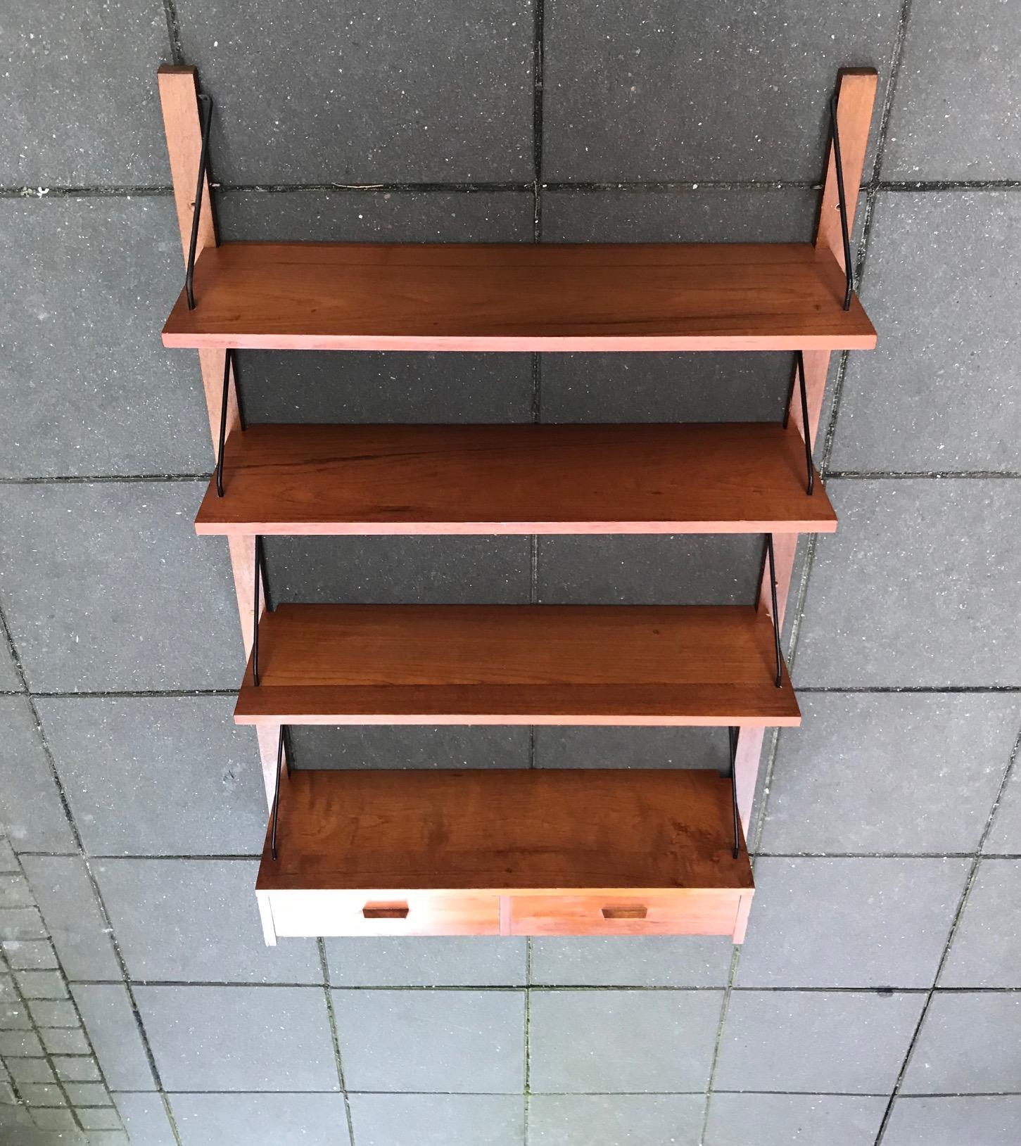 This modular wall unit with 4 shelves and a double drawer was made by PS System in Randers Denmark during the late 1960s. It is reminiscent in style to the Royal System by Poul Cadovius from 1948. Each shelf measures 75 x 24 cm and can, via the