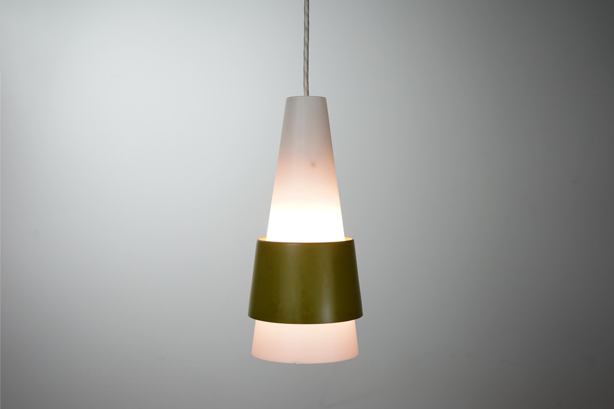 Glass and metal Danish pendant light, circa 1960's. Light consists of a slim frosted glass cone shaped shade with avocado green metal band.

Original condition, bottom rim shows tiny chip, selling as-is.

Please inquire for international and remote