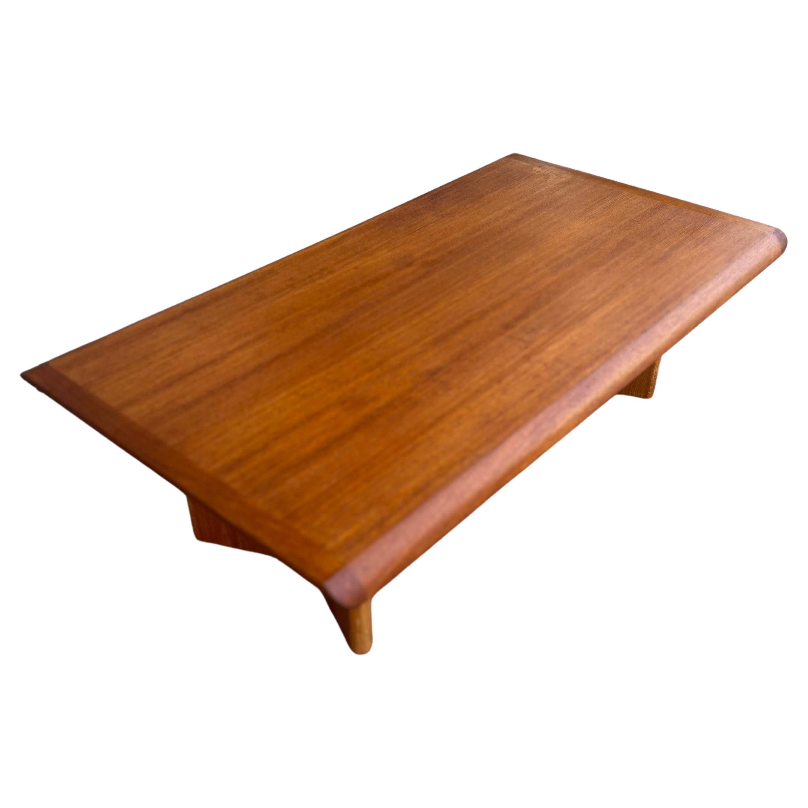 Beautiful Mid-Century Modern large coffee table, by Henning Kjærnullf for Vejle Støle & Møbelfabrik, 1970's. Featuring richly grained, gleaming teak and smooth, clean lines characteristic of classic Danish design, freshly refinished beautiful lines