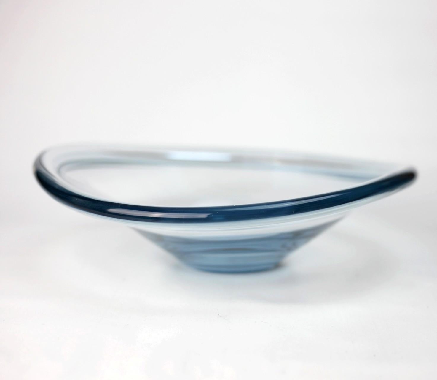 Mid-century aqua blue glass curved bowl by Per Lutken for Holmegaard of Denmark. A flat base and circular form features curved wave-like rounded edges. Handblown in Aqua grey glass with variances in color. Signed and excellent condition 

This