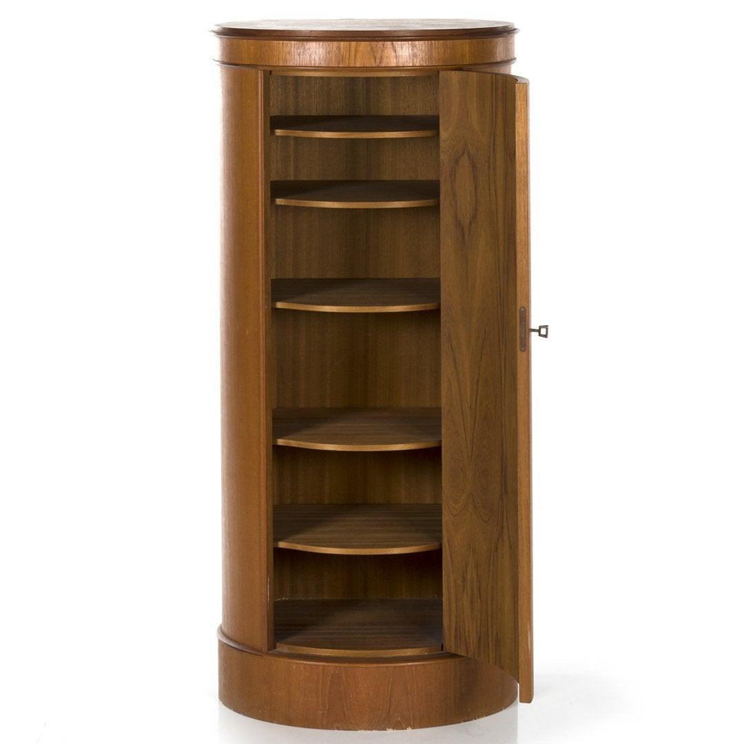 Un mobile in legno di palissandro del designer danese della metà del secolo scorso Johannes Sorth. L'armadietto semicircolare ha un piano e una base conformi, mentre la cassa ha un'anta che si apre per rivelare i ripiani interni.
Il retro è
