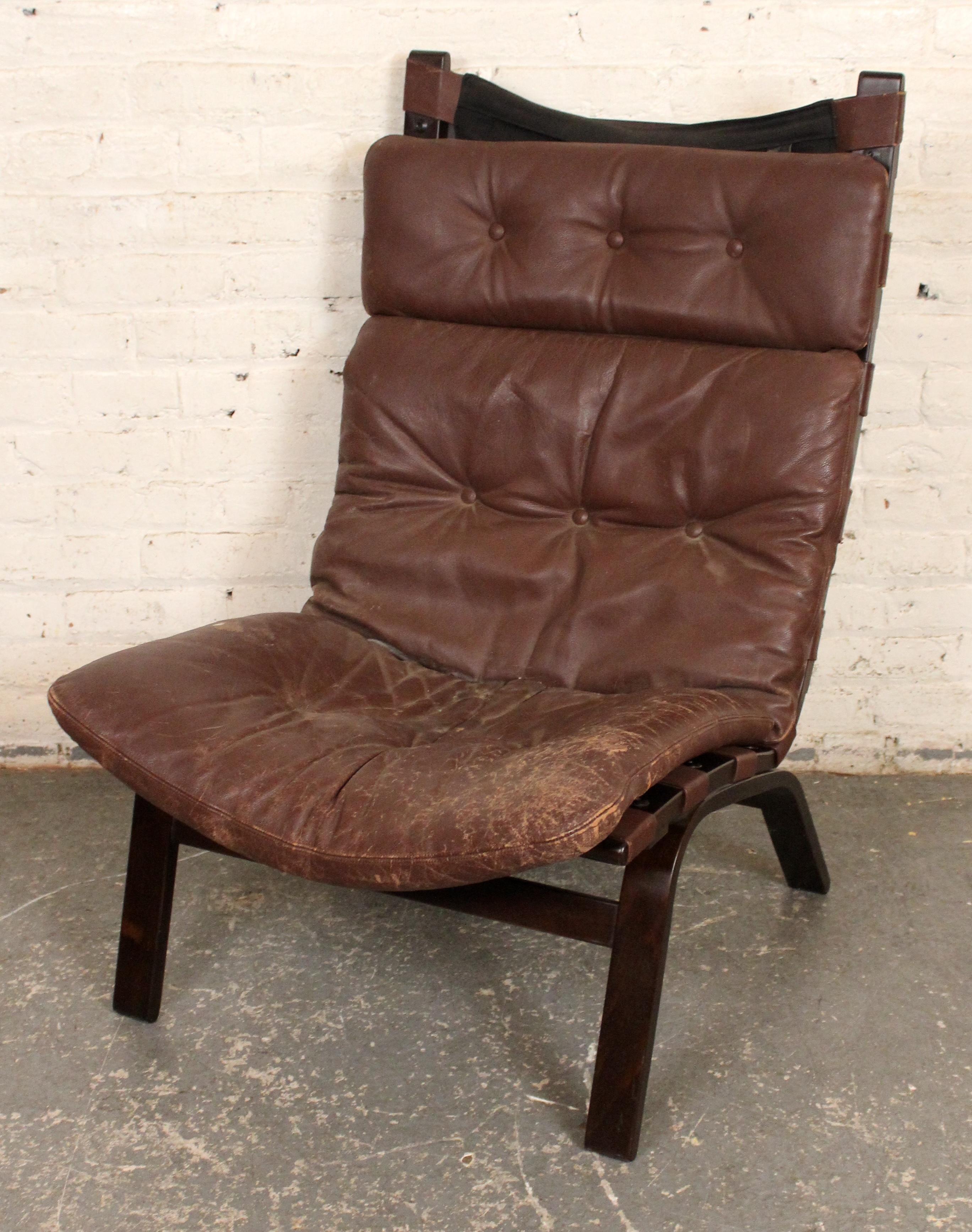 Elegant Danish mid-century lounge chair by Farstrup Møbelfabrik, featuring a sculptural bentwood frame and original brown leather upholstery. With its gently reclined profile, padded seat and back, and signature Scandinavian simplicity, this piece